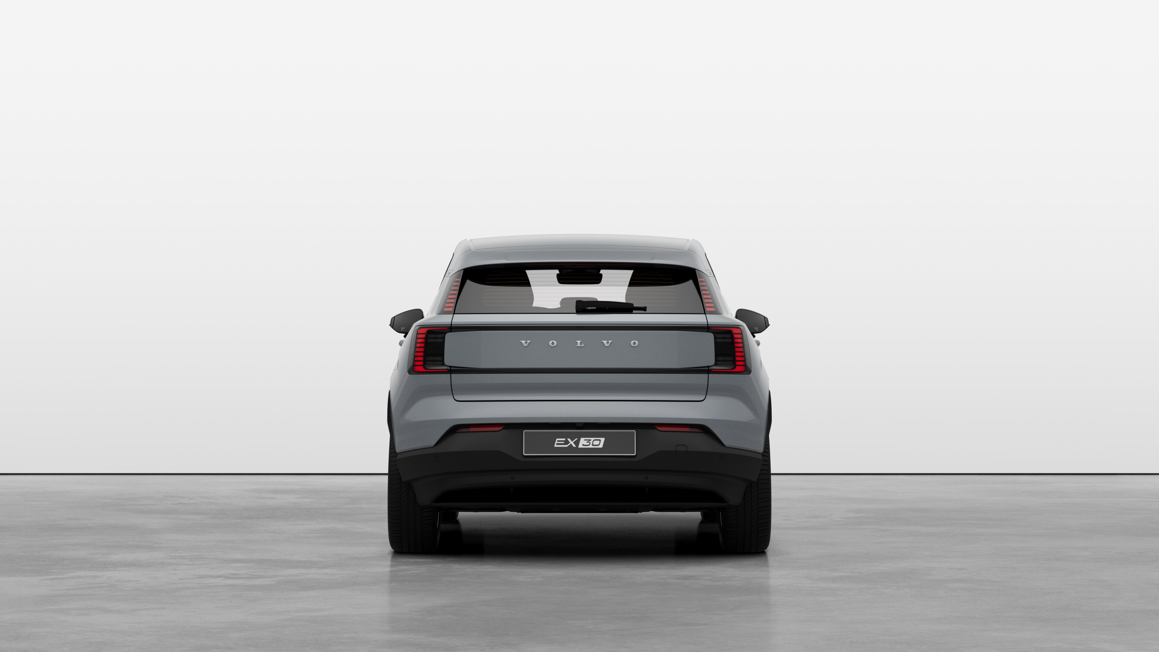 Vista traseira do automóvel Volvo contra um fundo de estúdio simples.