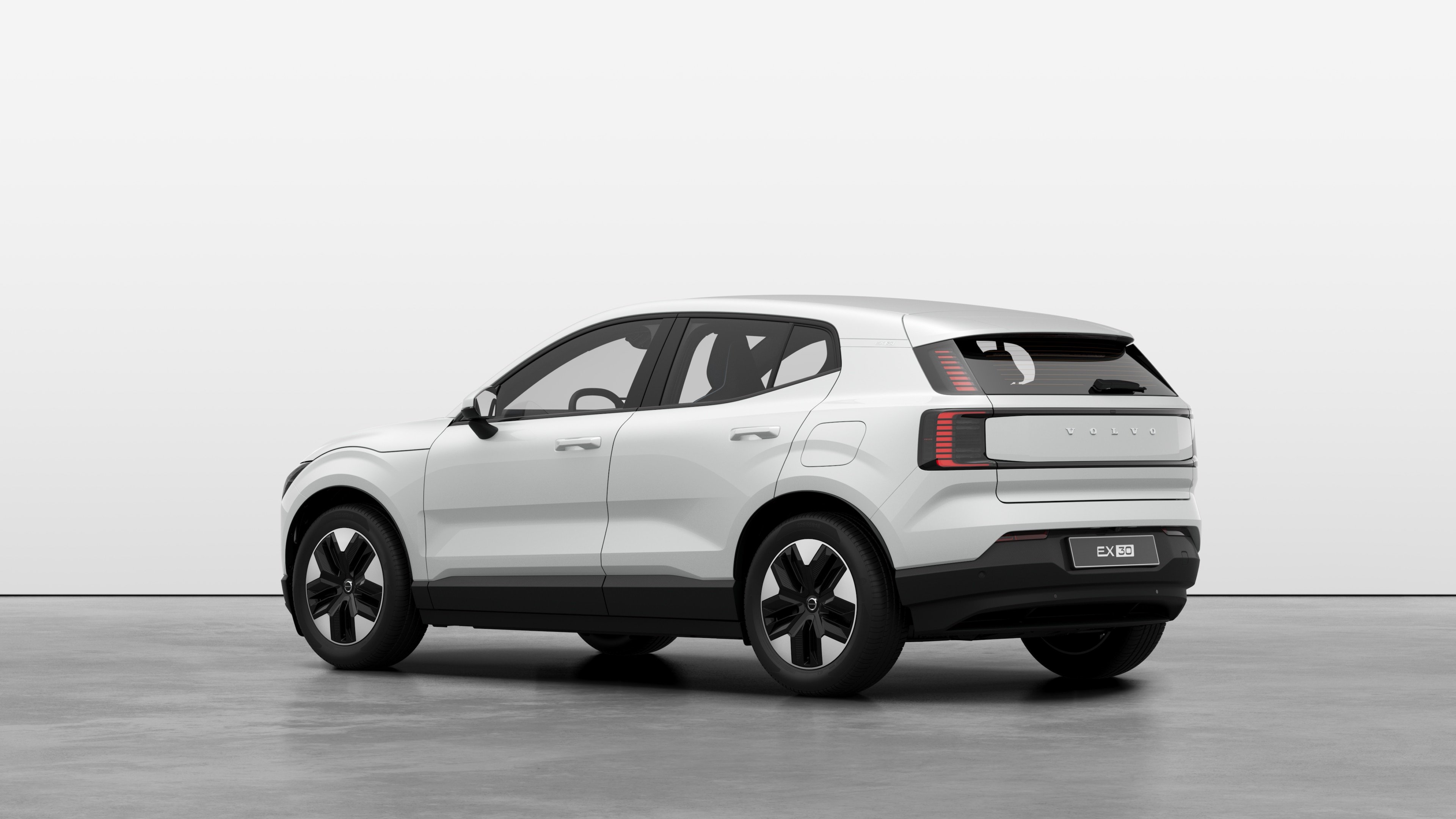 Volvo car rear three-quarter view in a plain studio background.