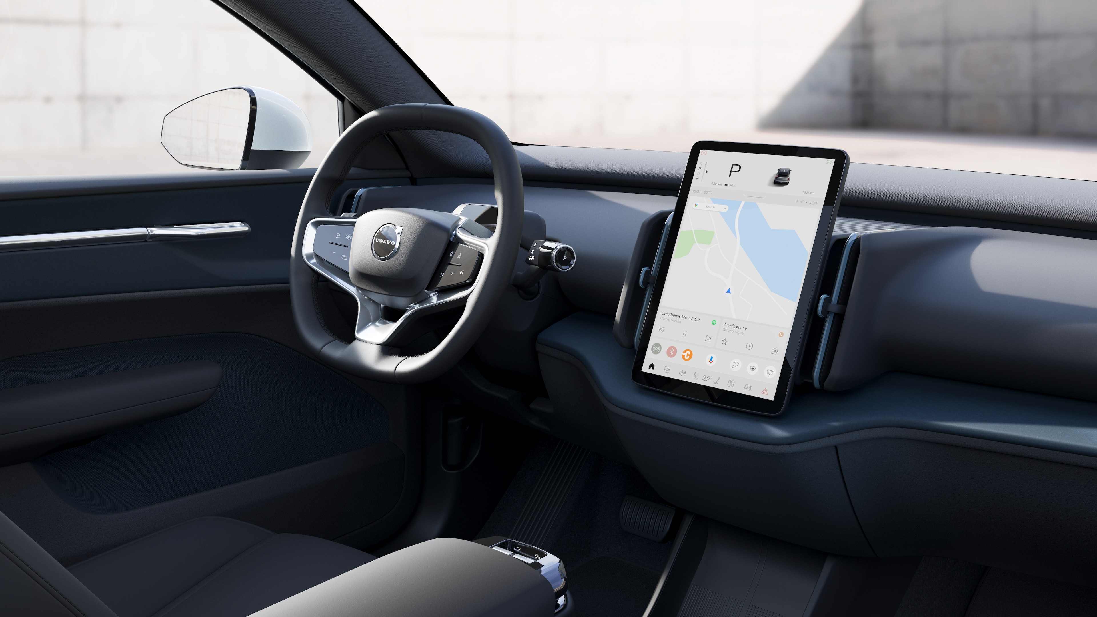 Volvo car interior showing dashboard, steering wheel, and center console with digital display in an open road background.