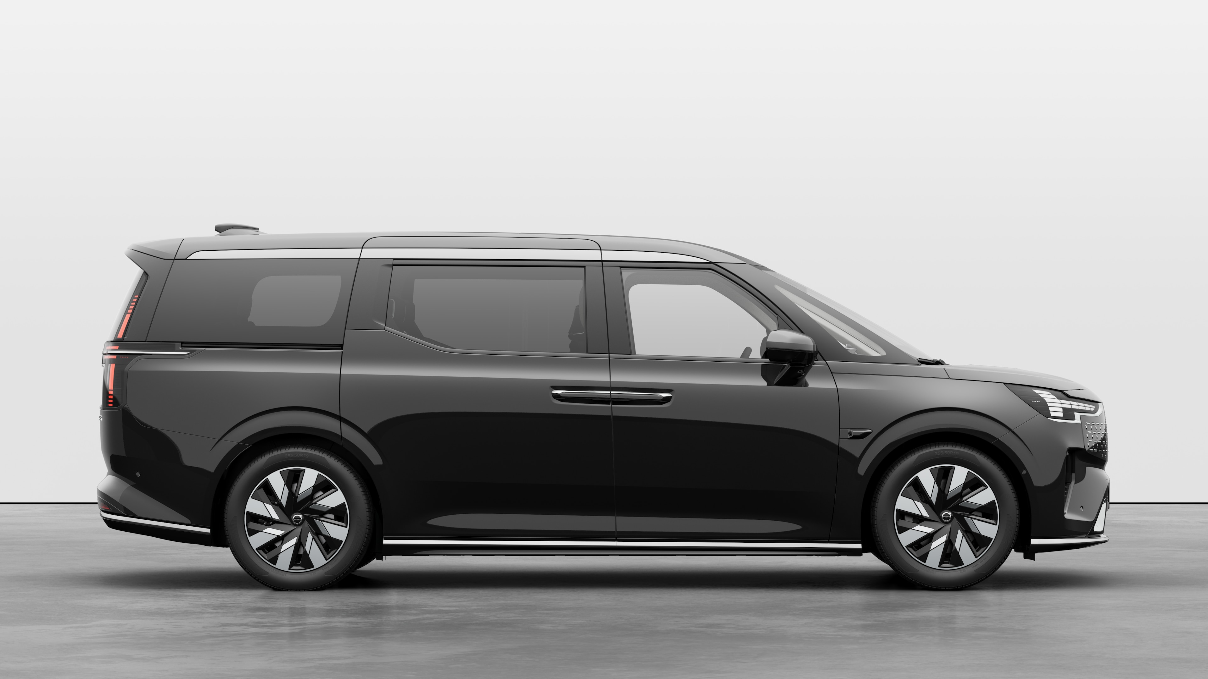 Volvo car side view on plain studio background displaying closed doors and visible wheel design.