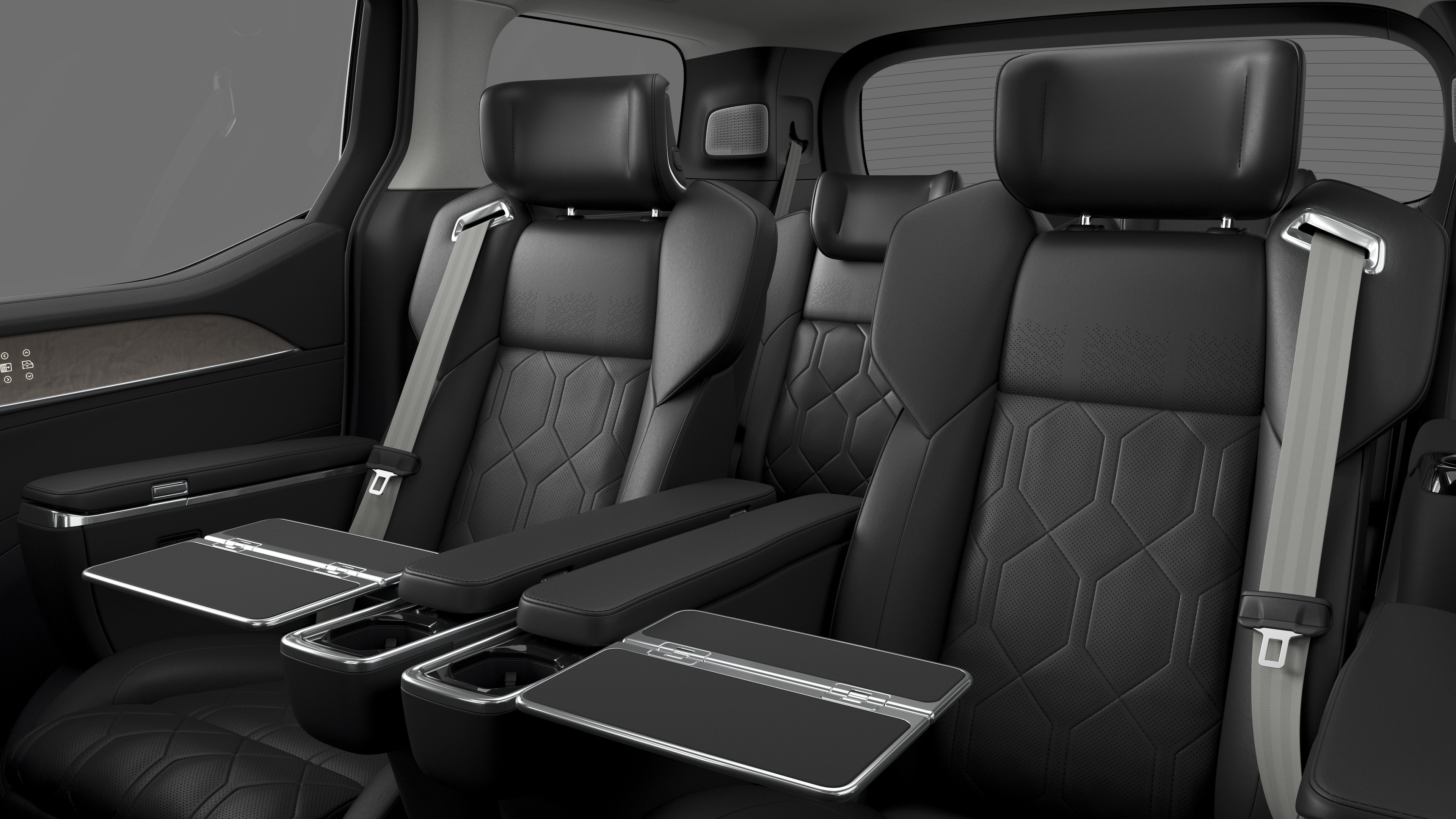 Volvo car interior showing rear passenger seats and center console in plain studio background.