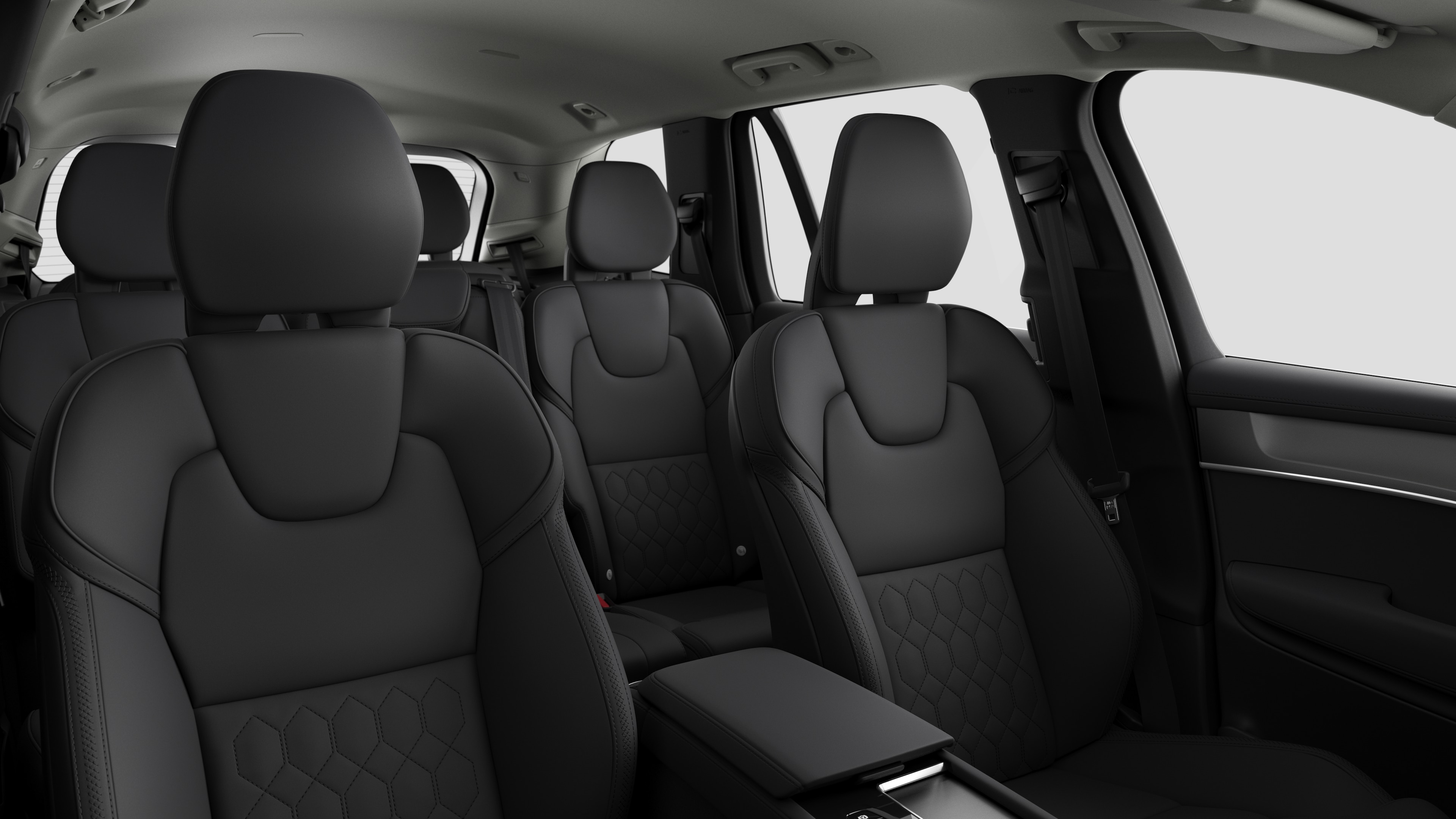 Volvo car interior showing rear passenger seats and center console in plain studio background.