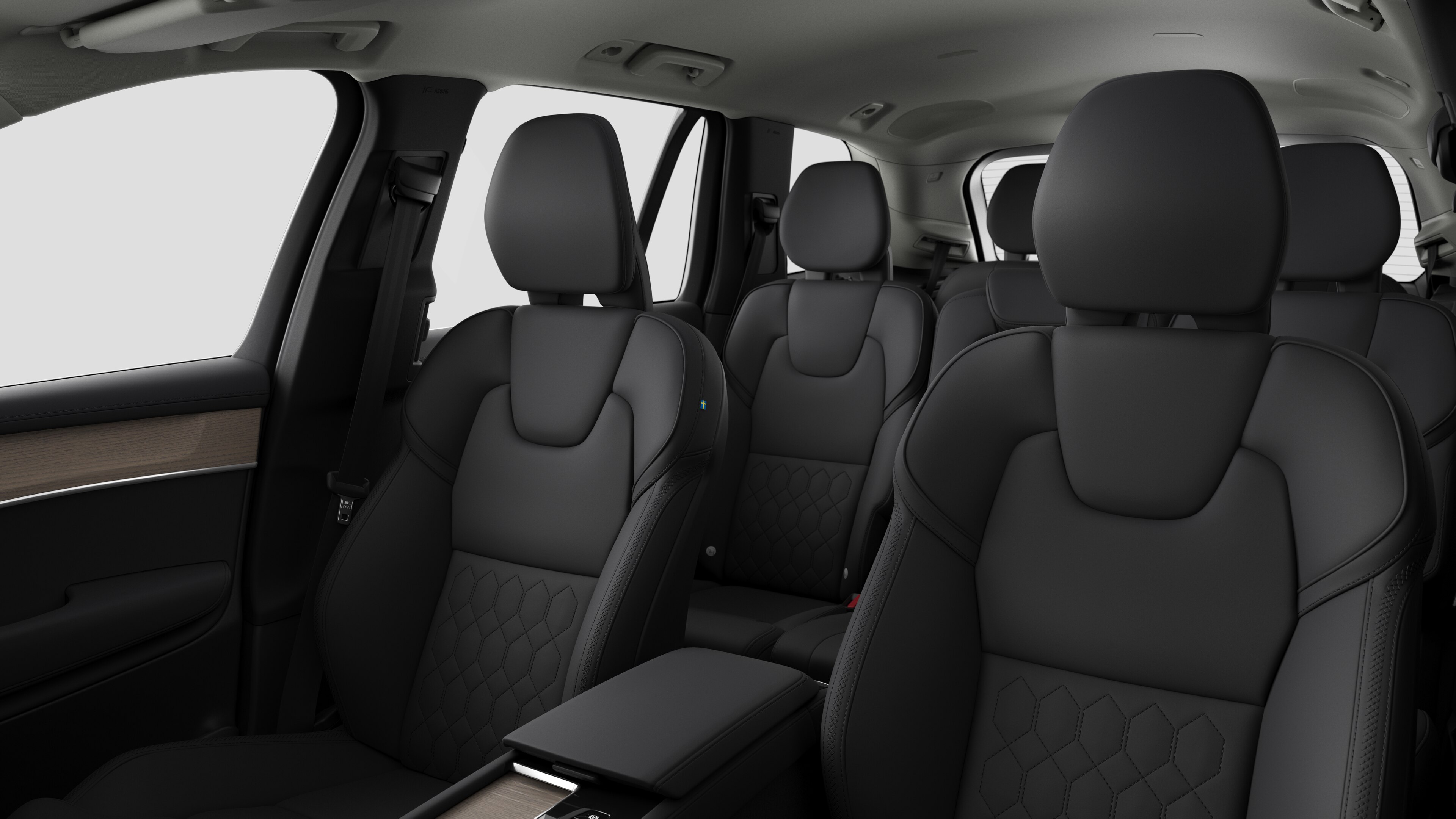 Volvo car interior showing rear passenger seats and center console in plain studio background.