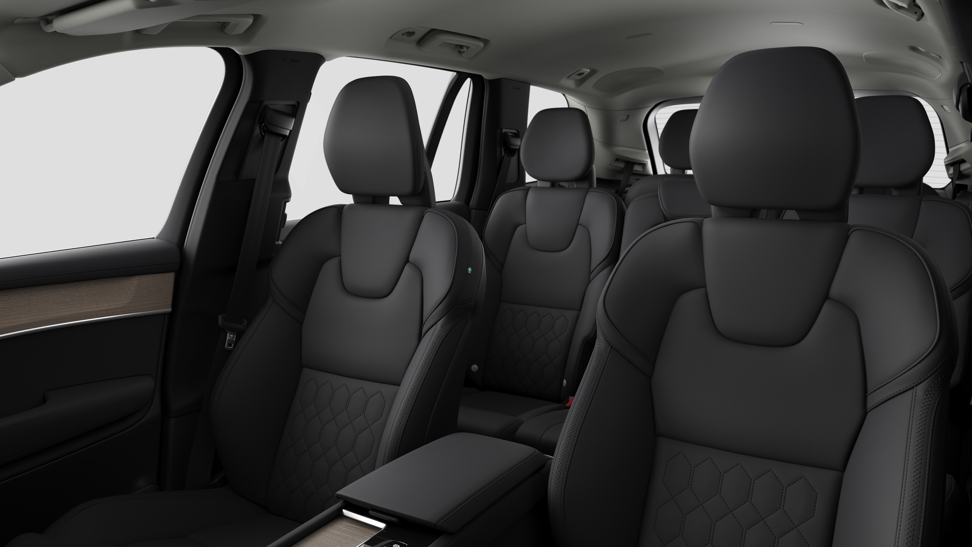 Volvo car interior showing rear passenger seats and center console in plain studio background.