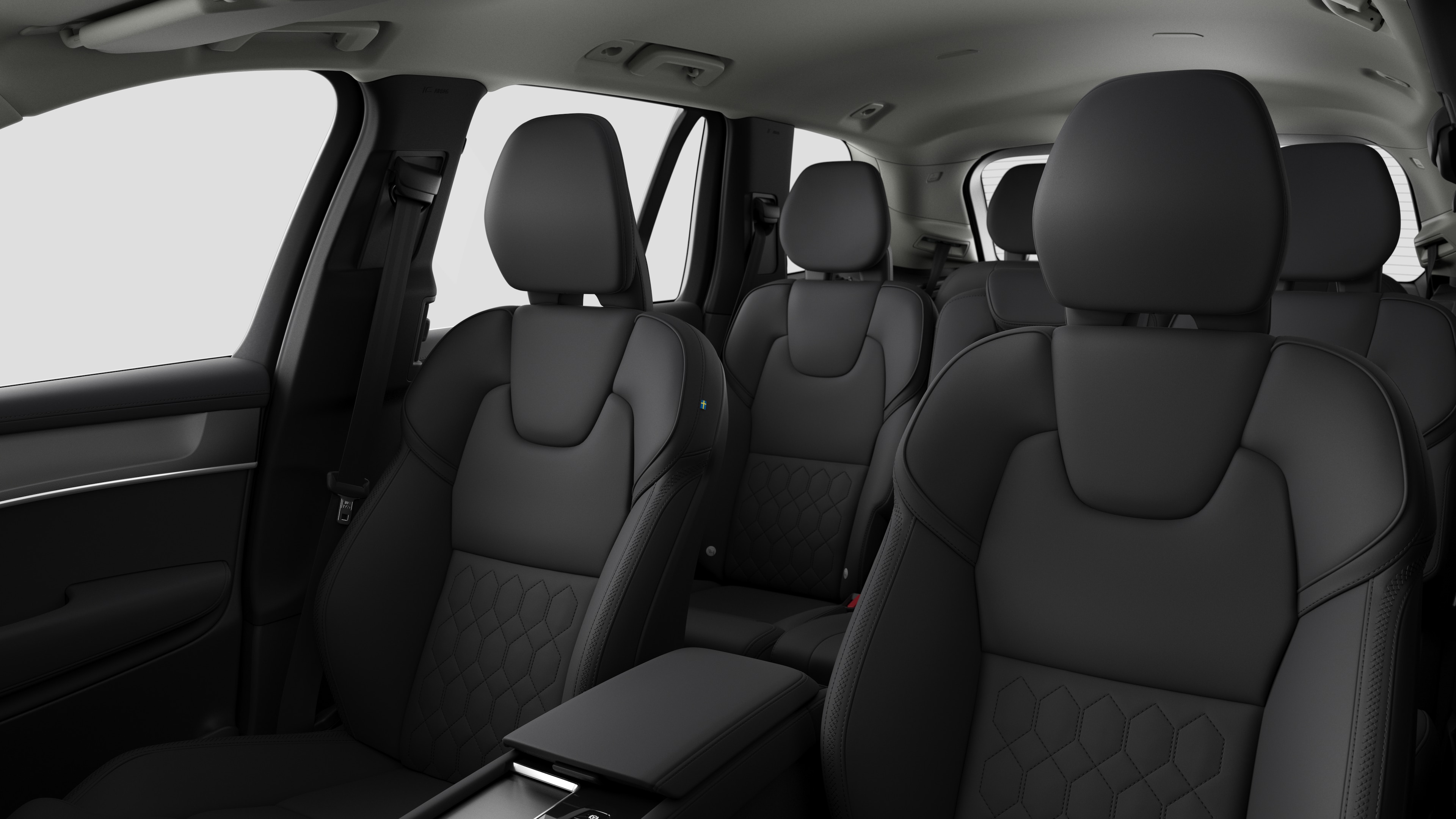 Volvo car interior showing rear passenger seats and center console in plain studio background.