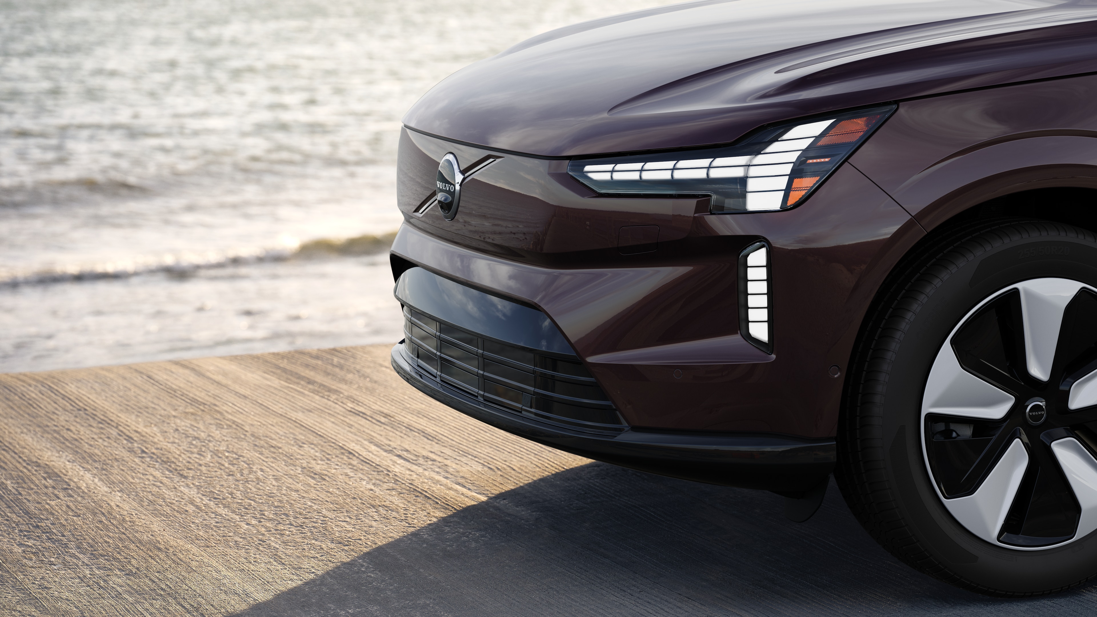 Volvo car exterior in three-quarter view against an industrial concrete wall background.