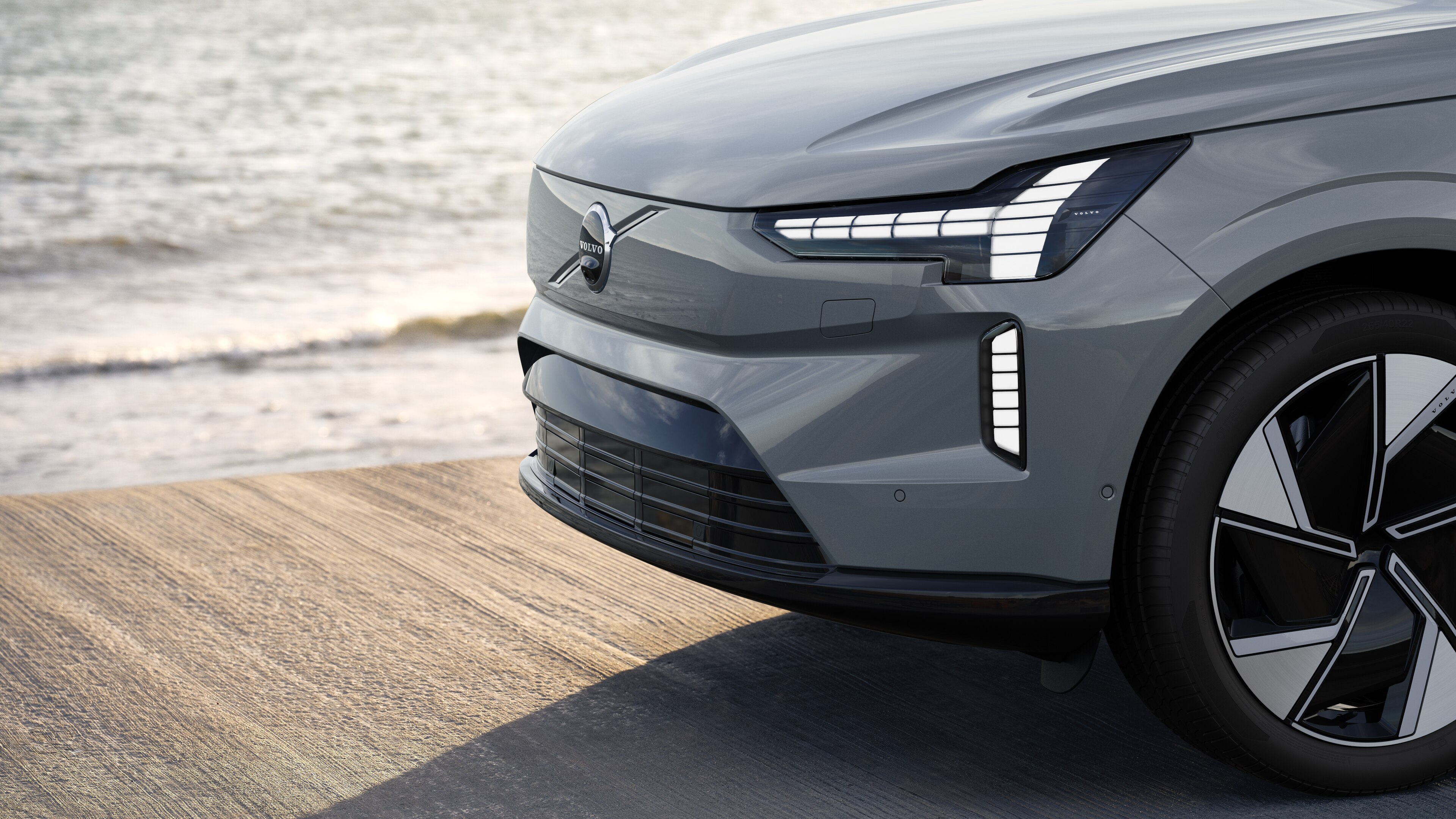 Volvo car exterior in three-quarter view against an industrial concrete wall background.