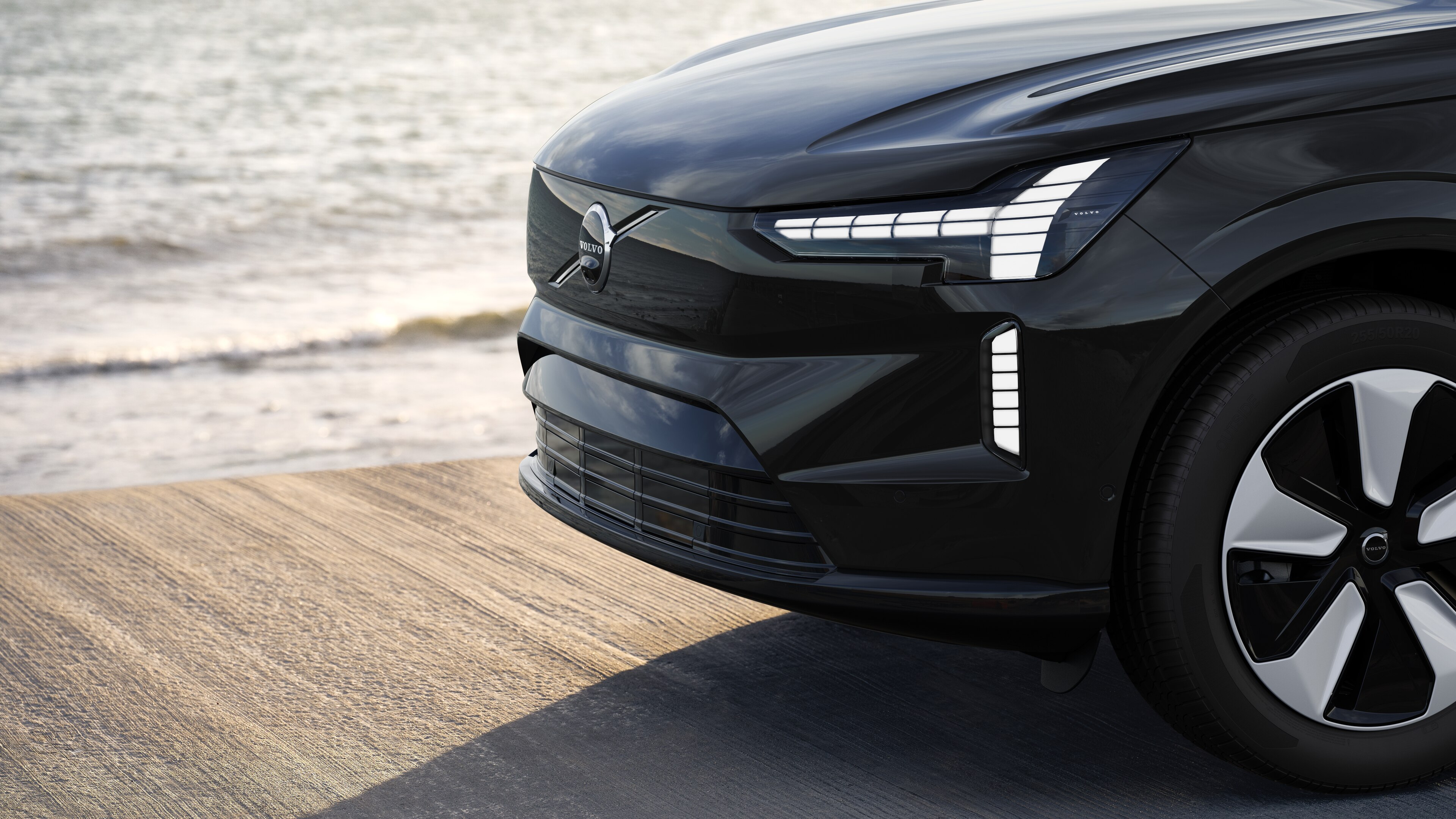 Volvo car exterior in three-quarter view against an industrial concrete wall background.