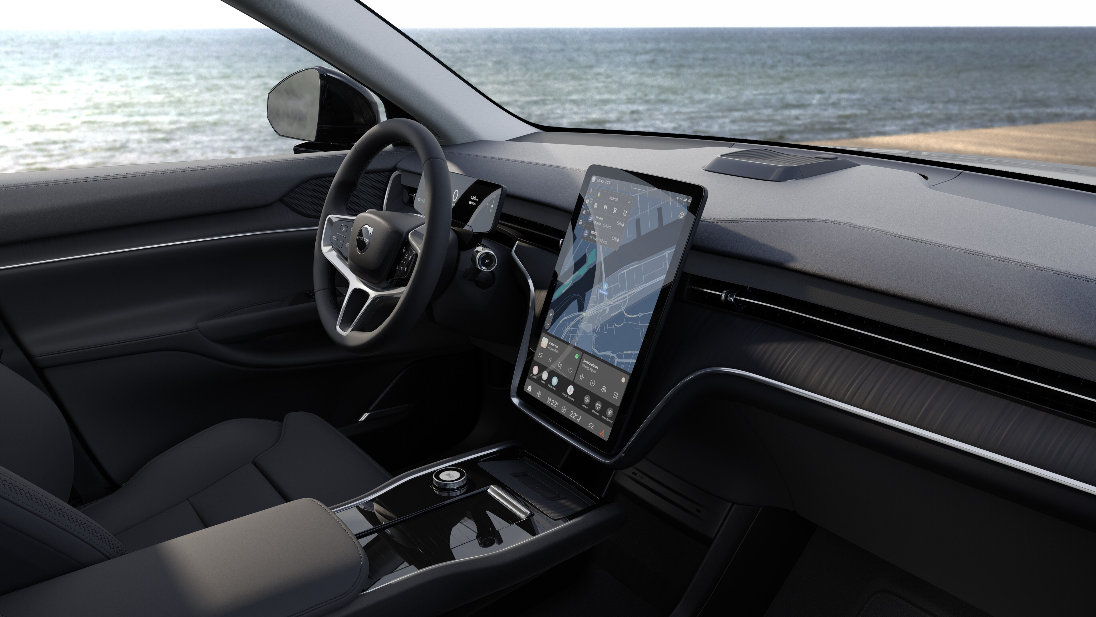 Wnętrze samochodu Volvo z deską rozdzielczą, kierownicą i konsolą środkową z cyfrowym wyświetlaczem na otwartym tle drogi.