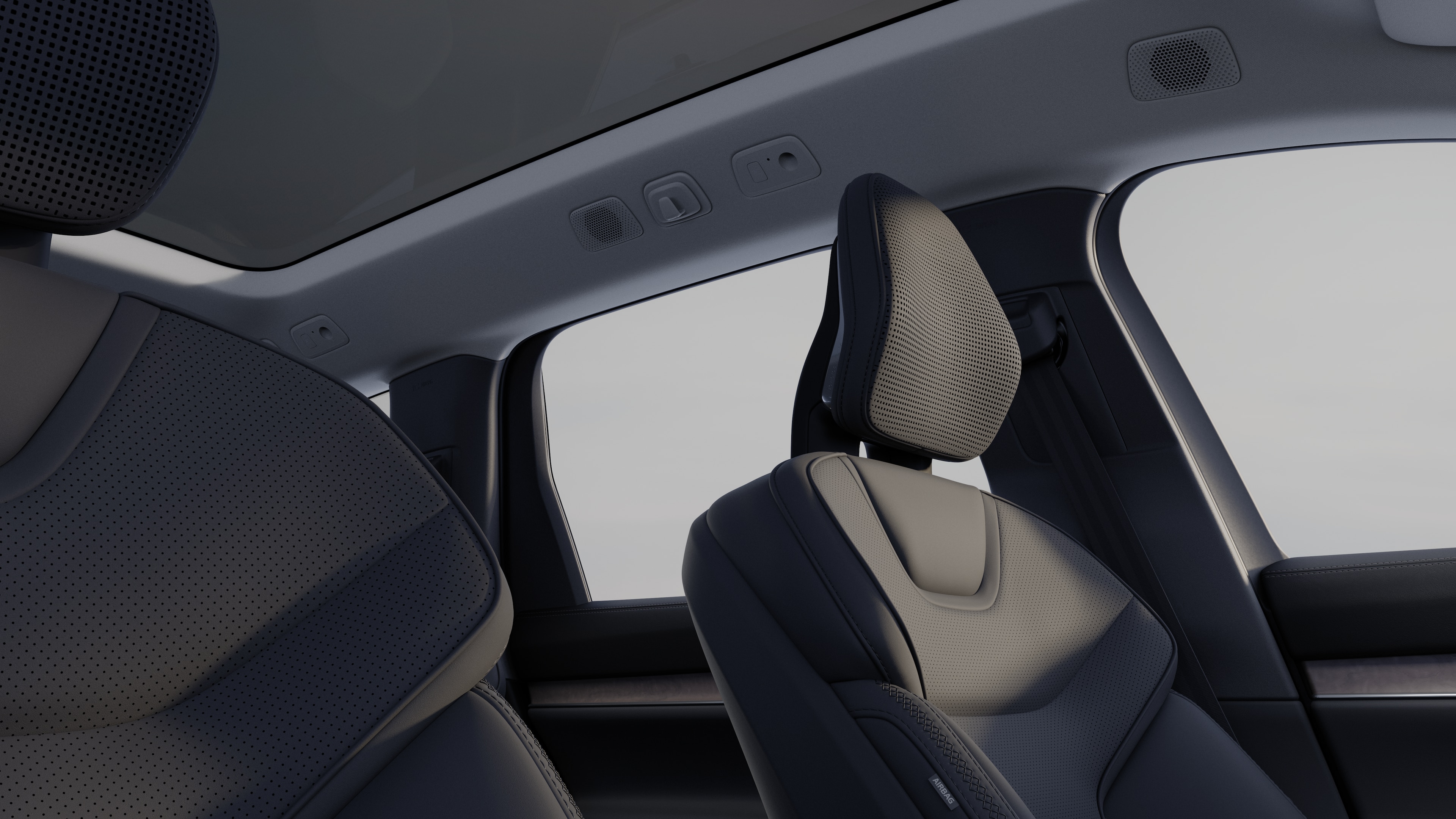 Volvo car interior showing front and rear passenger seats, steering wheel, dashboard, and center console against a plain studio background.