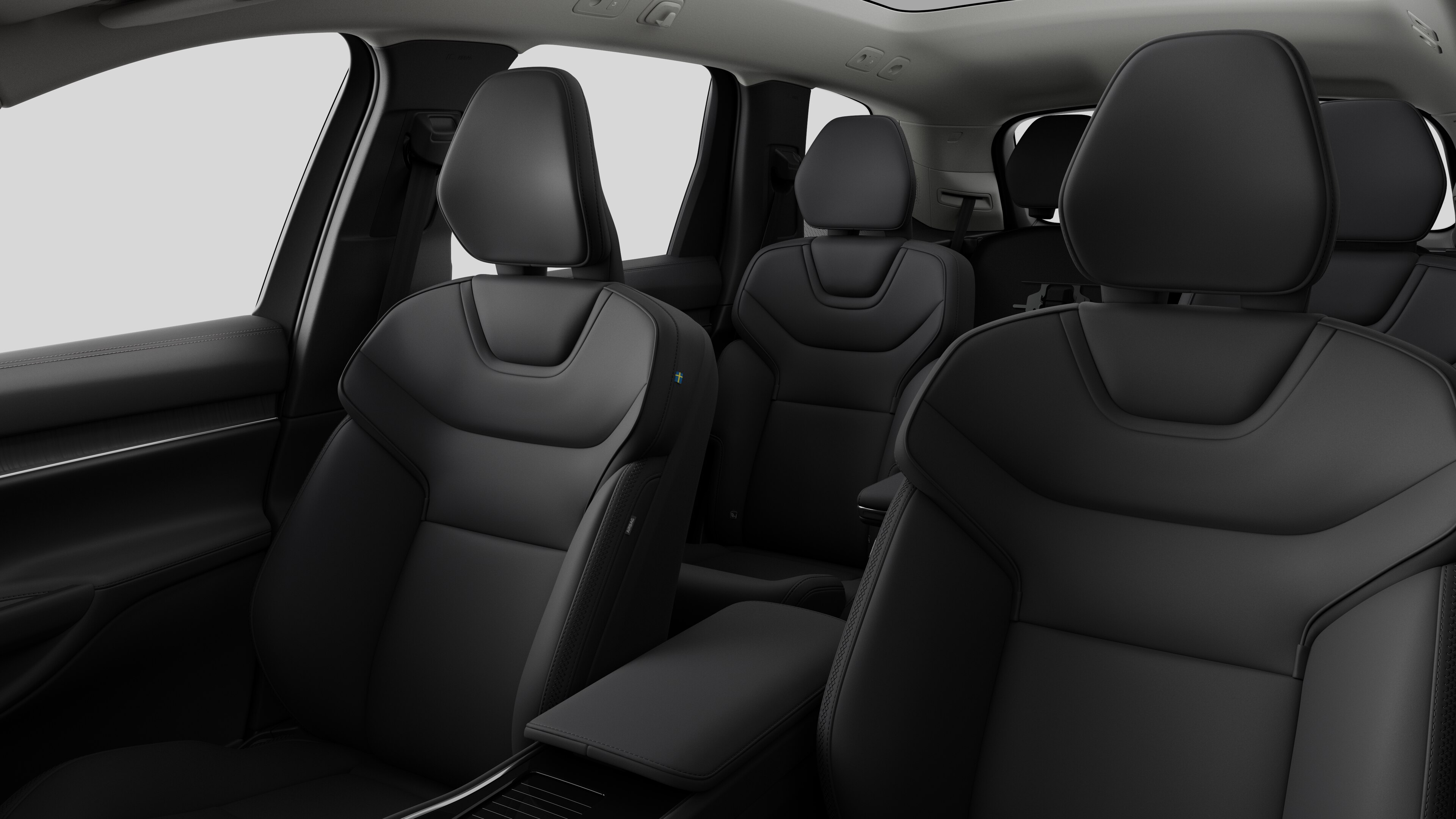 Intérieur d’une Volvo montrant les sièges passagers arrière et la console centrale dans un studio uni.