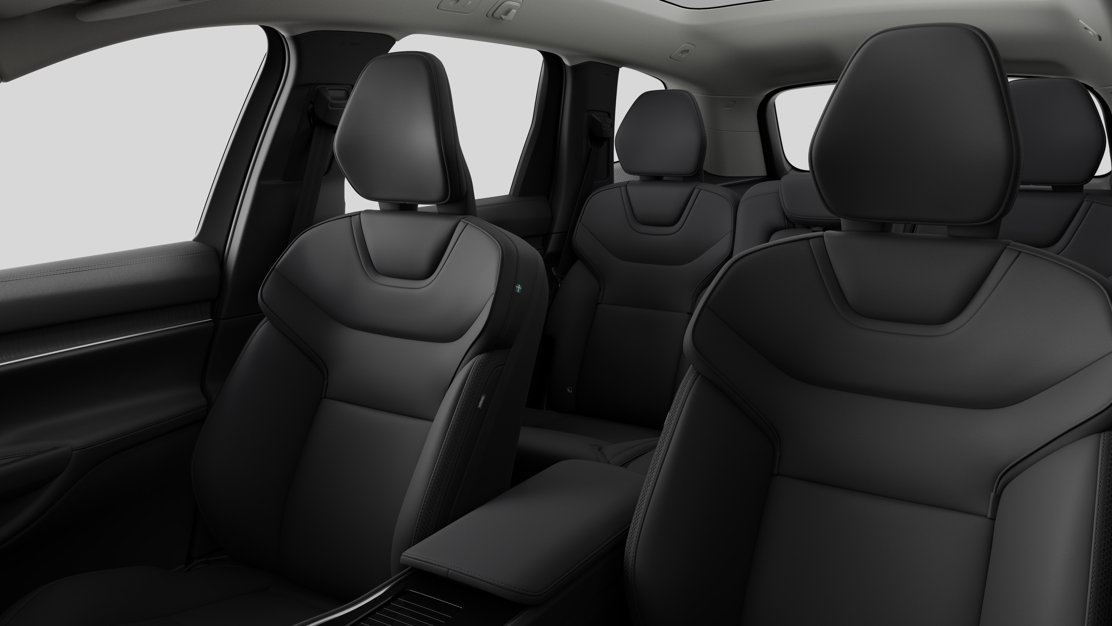 Innenraum eines Volvo mit Rücksitzen und Mittelkonsole im schlichten Studiohintergrund.