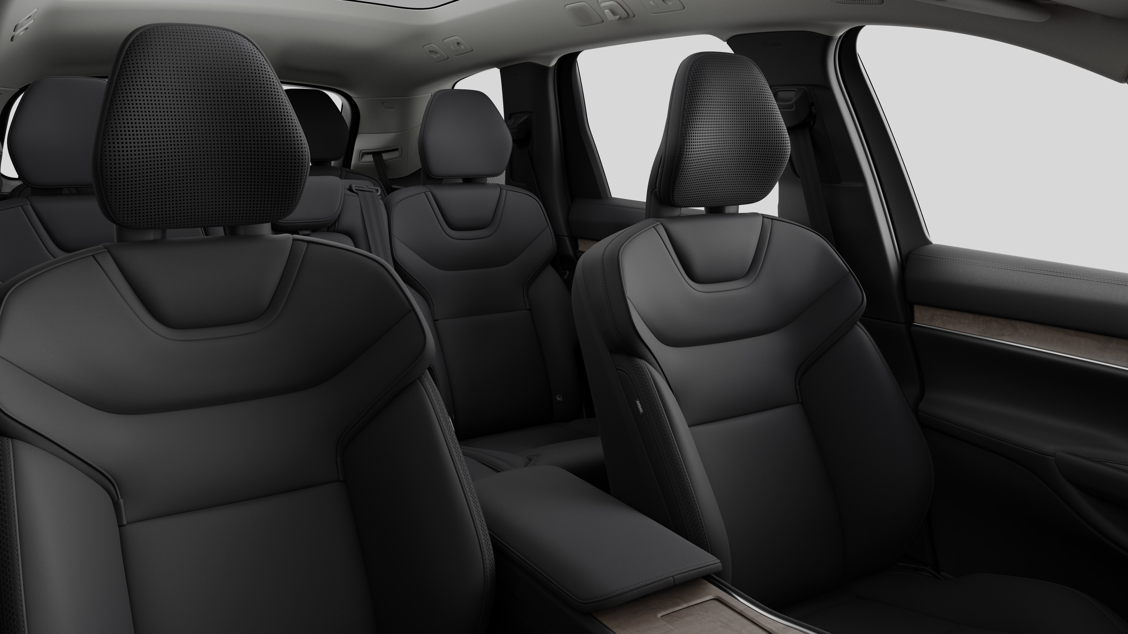 Volvo car interior showing rear passenger seats and center console in plain studio background.