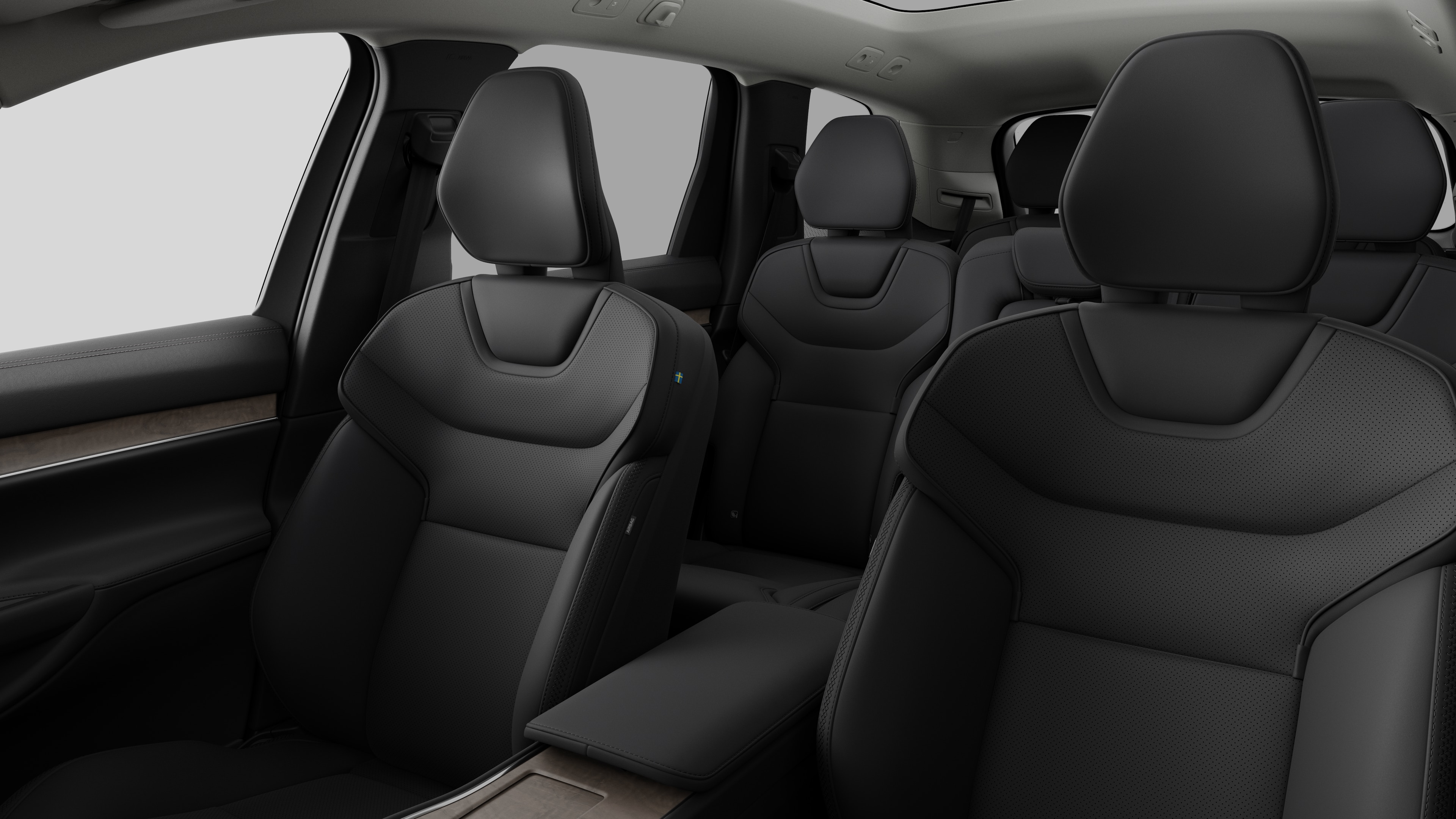 Innenraum eines Volvo mit Rücksitzen und Mittelkonsole im schlichten Studiohintergrund.