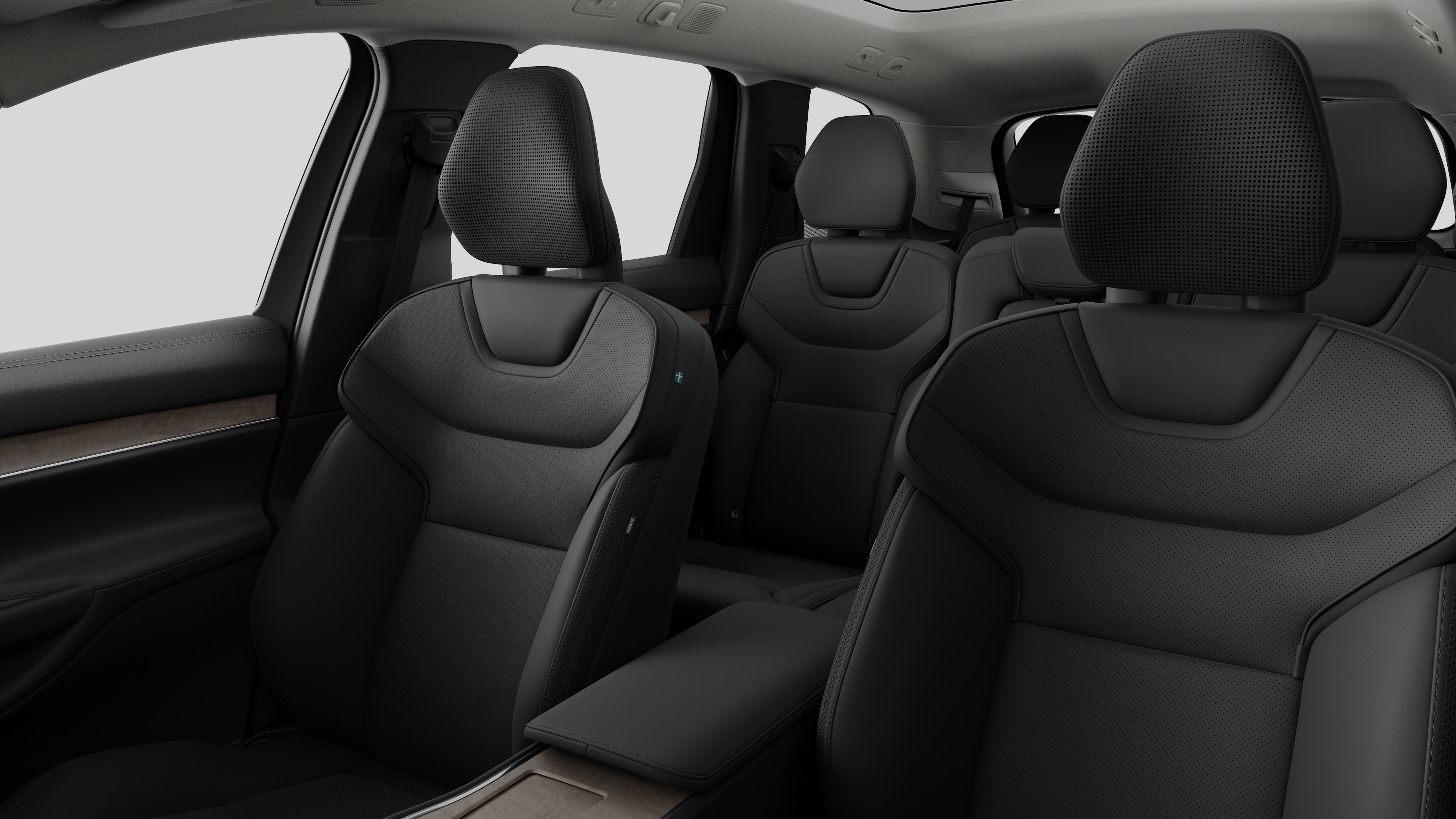 Interior do carro Volvo mostrando os bancos traseiros do passageiro e o console central em fundo de estúdio simples.