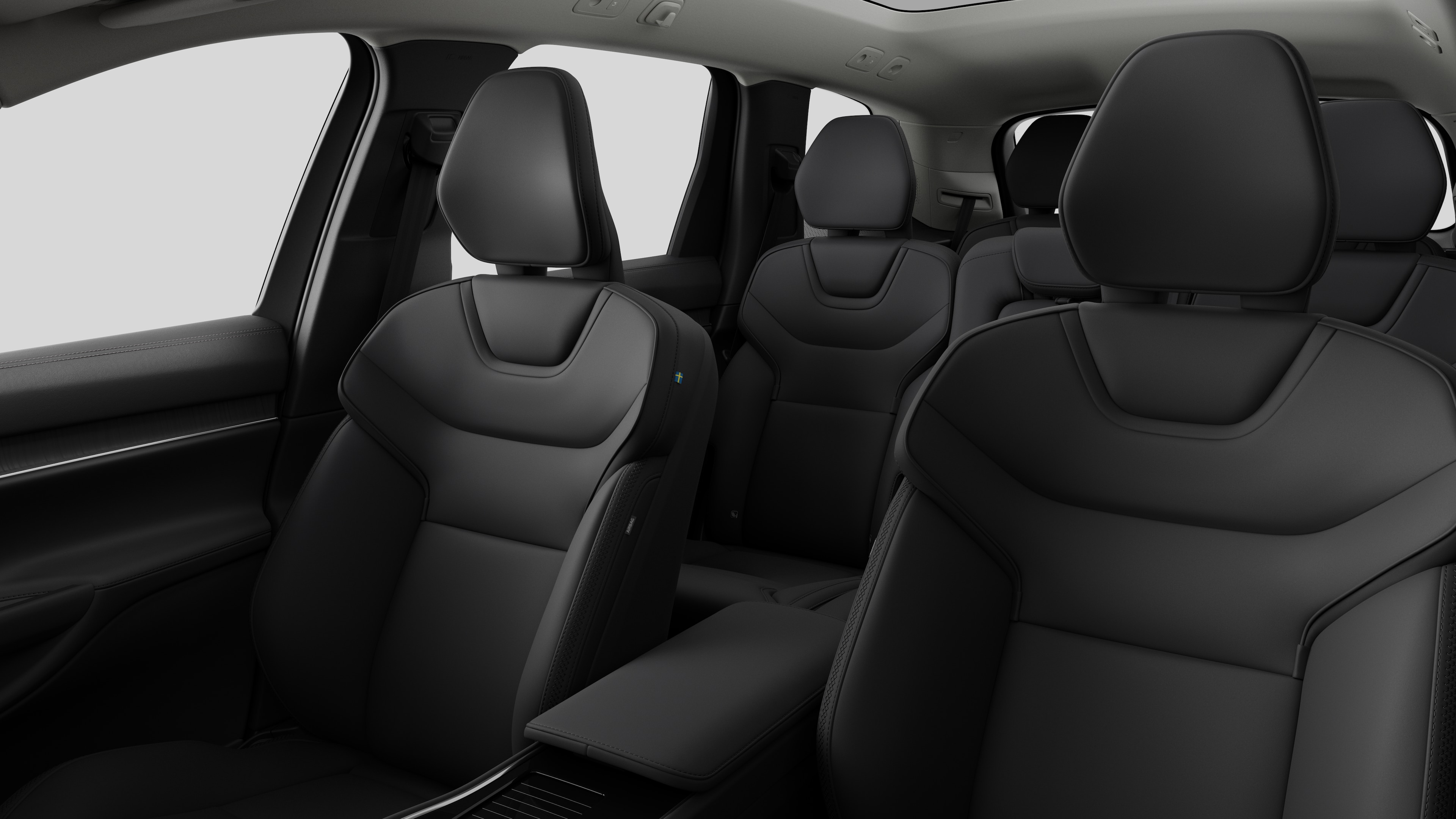 Intérieur d’une Volvo montrant les sièges passager arrière et la console centrale en arrière-plan de studio.