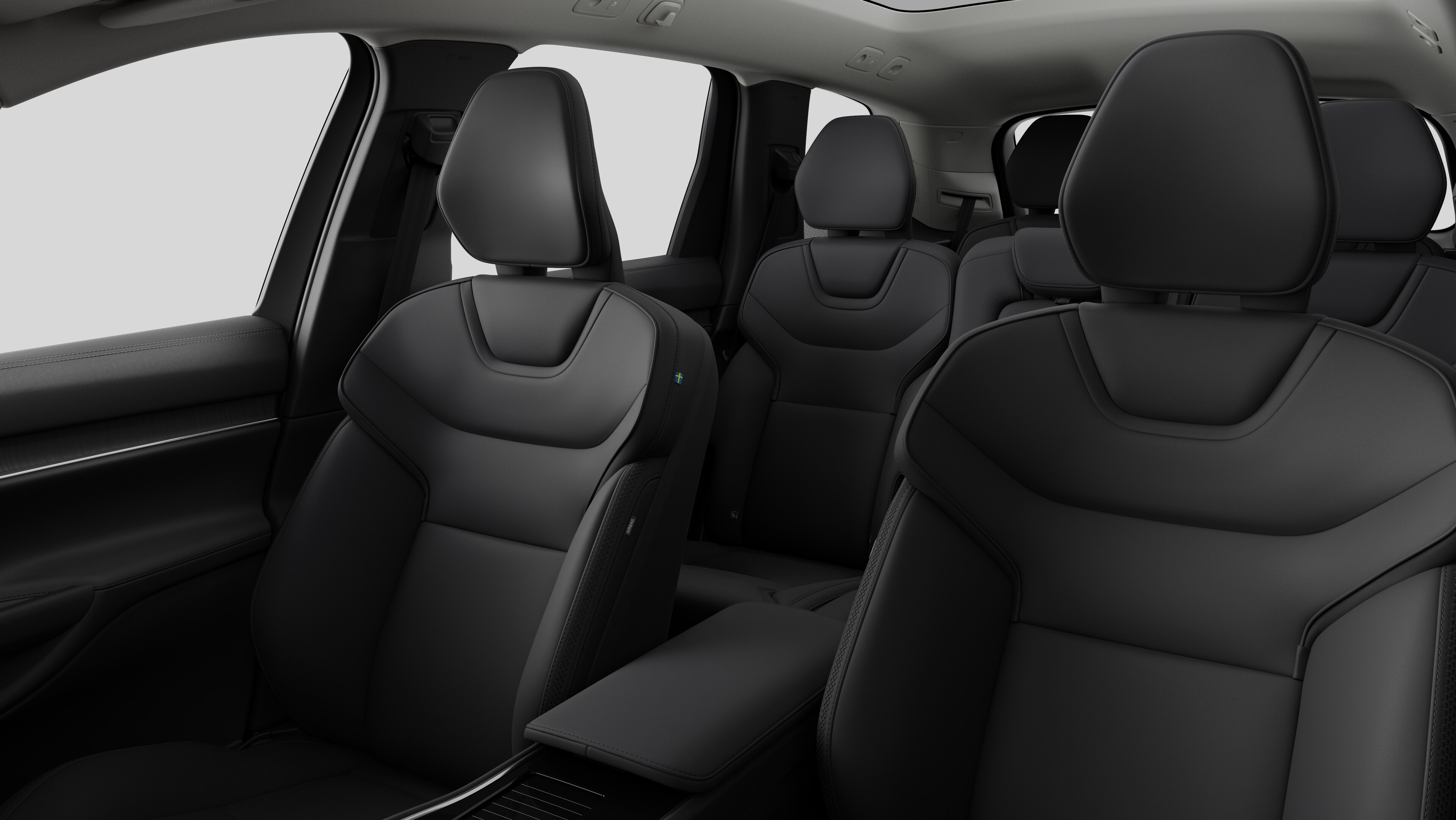 Interior do automóvel Volvo a mostrar os bancos do passageiro traseiro e a consola central em fundo de estúdio simples.