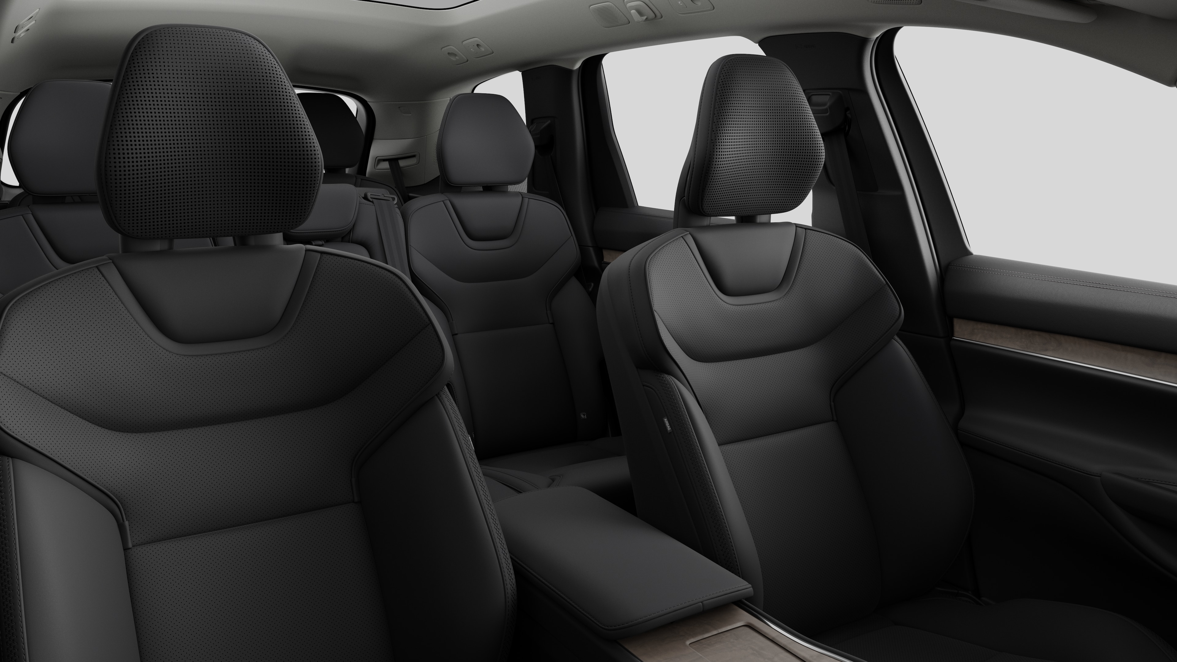 Volvo car interior showing rear passenger seats and center console in plain studio background.