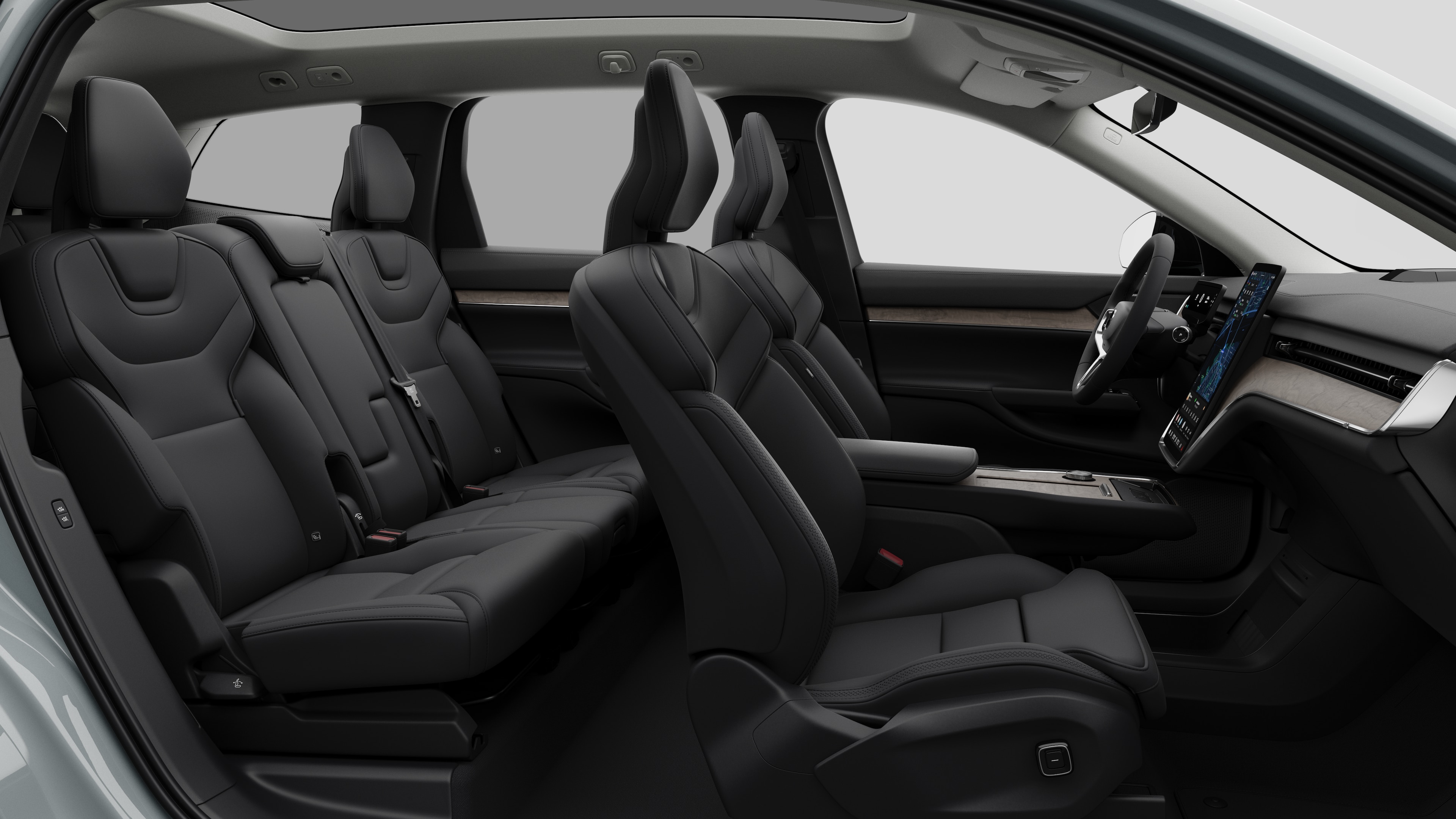 Volvo car interior side view showcasing front seats, rear passenger seats, steering wheel, dashboard, and center console, set against plain studio background.