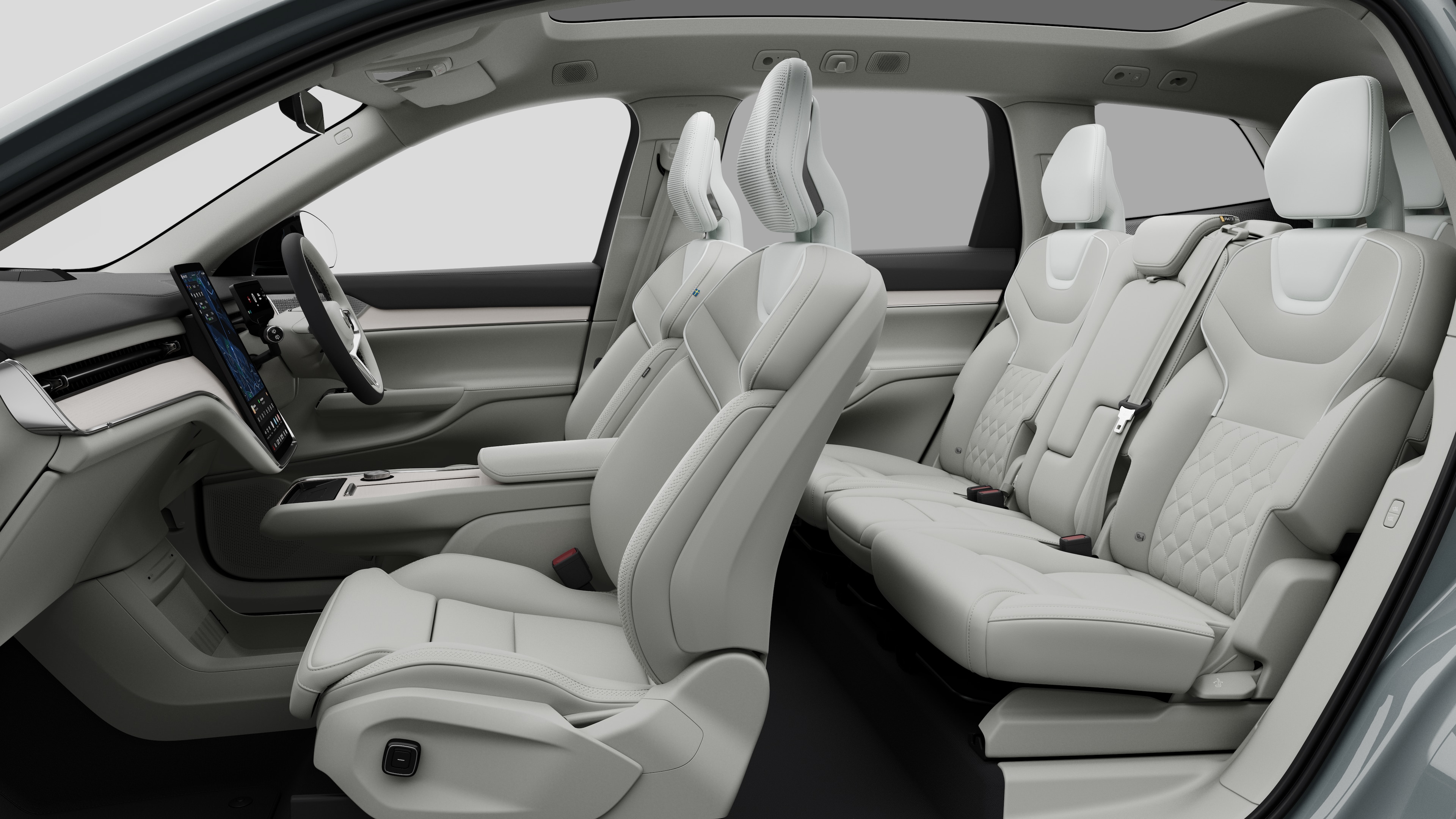Volvo car interior side view showcasing front seats, rear passenger seats, steering wheel, dashboard, and centre console, set against plain studio background.
