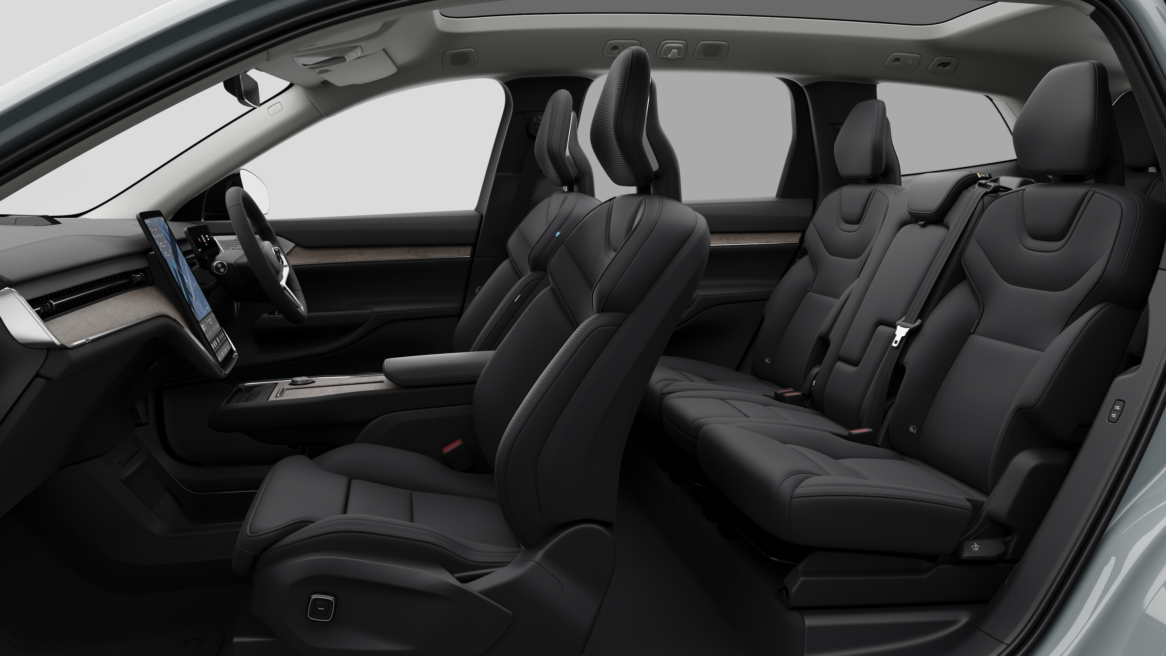 Volvo car interior side view showcasing front seats, rear passenger seats, steering wheel, dashboard, and center console, set against plain studio background.