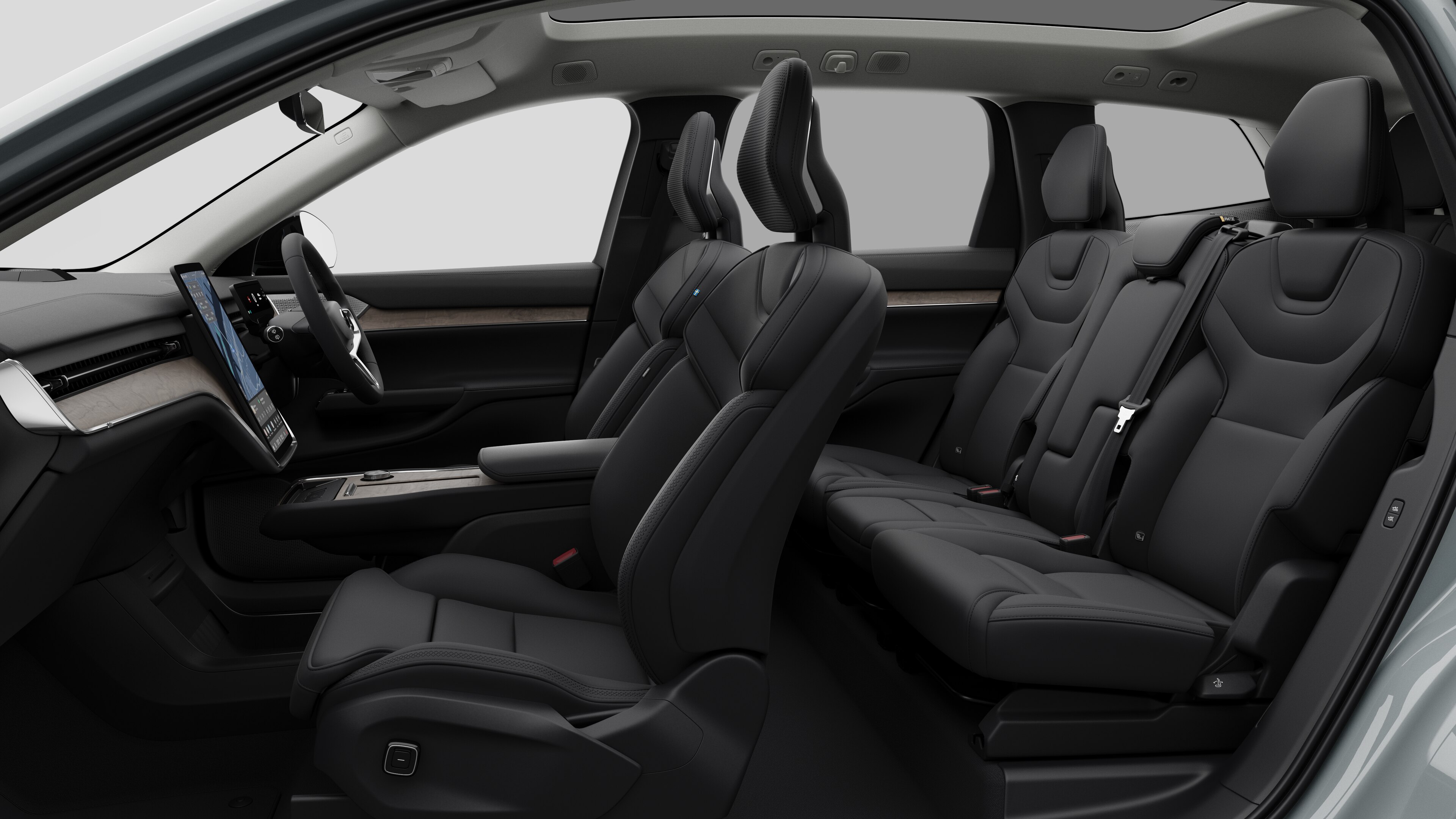 Volvo car interior side view showcasing front seats, rear passenger seats, steering wheel, dashboard, and center console, set against plain studio background.