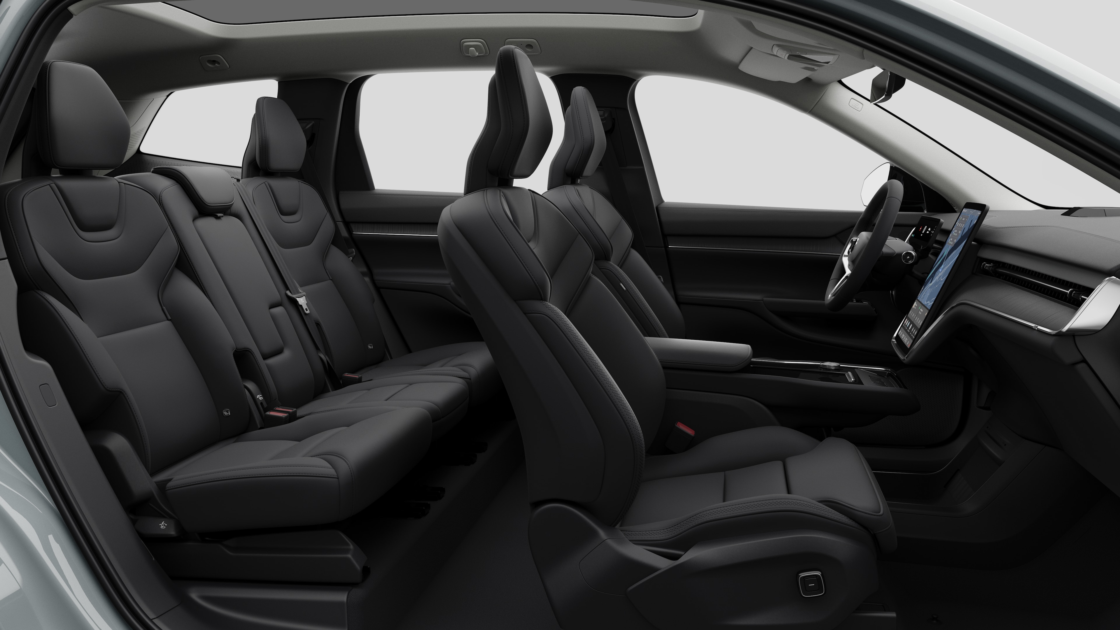 Widok z boku wnętrza samochodu Volvo z przednimi fotelami, tylnymi siedzeniami pasażera, kierownicą, deską rozdzielczą i konsolą środkową na tle zwykłego studia.