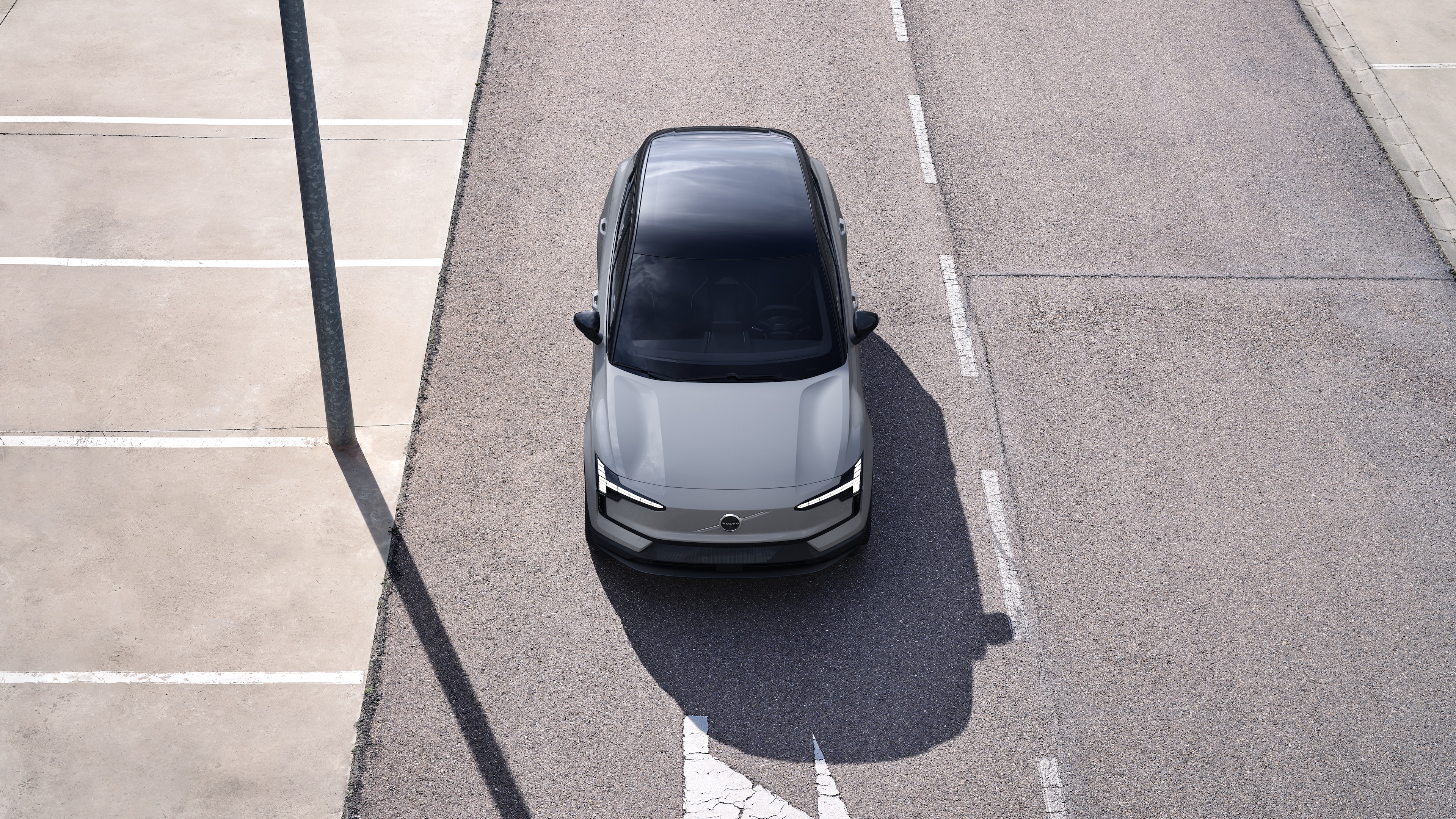 Volvo car exterior in three-quarter view on an urban street background, showing one side, roof, and part of the front.