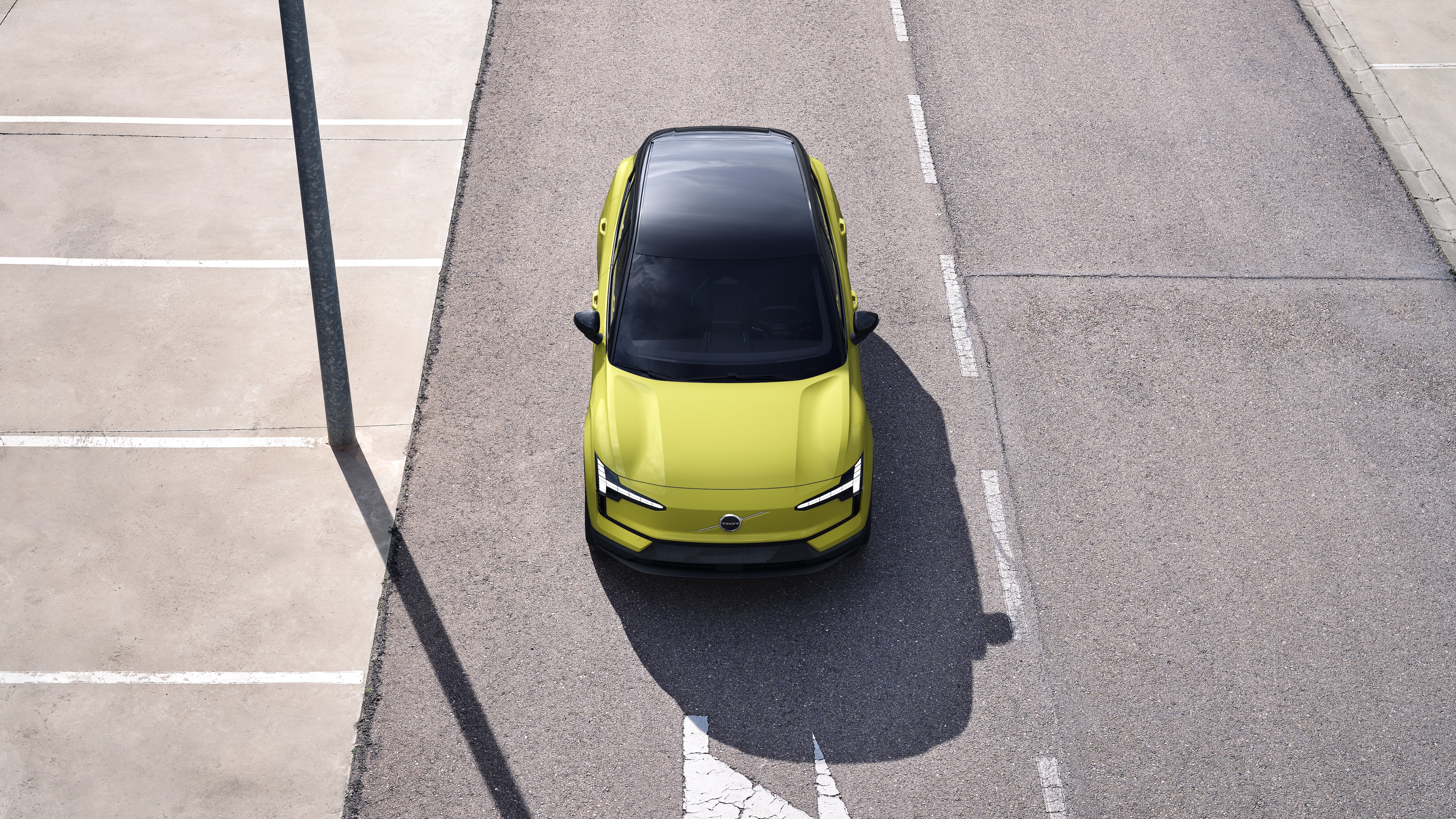 Volvo car exterior in three-quarter view on an urban street background, showing one side, roof, and part of the front.