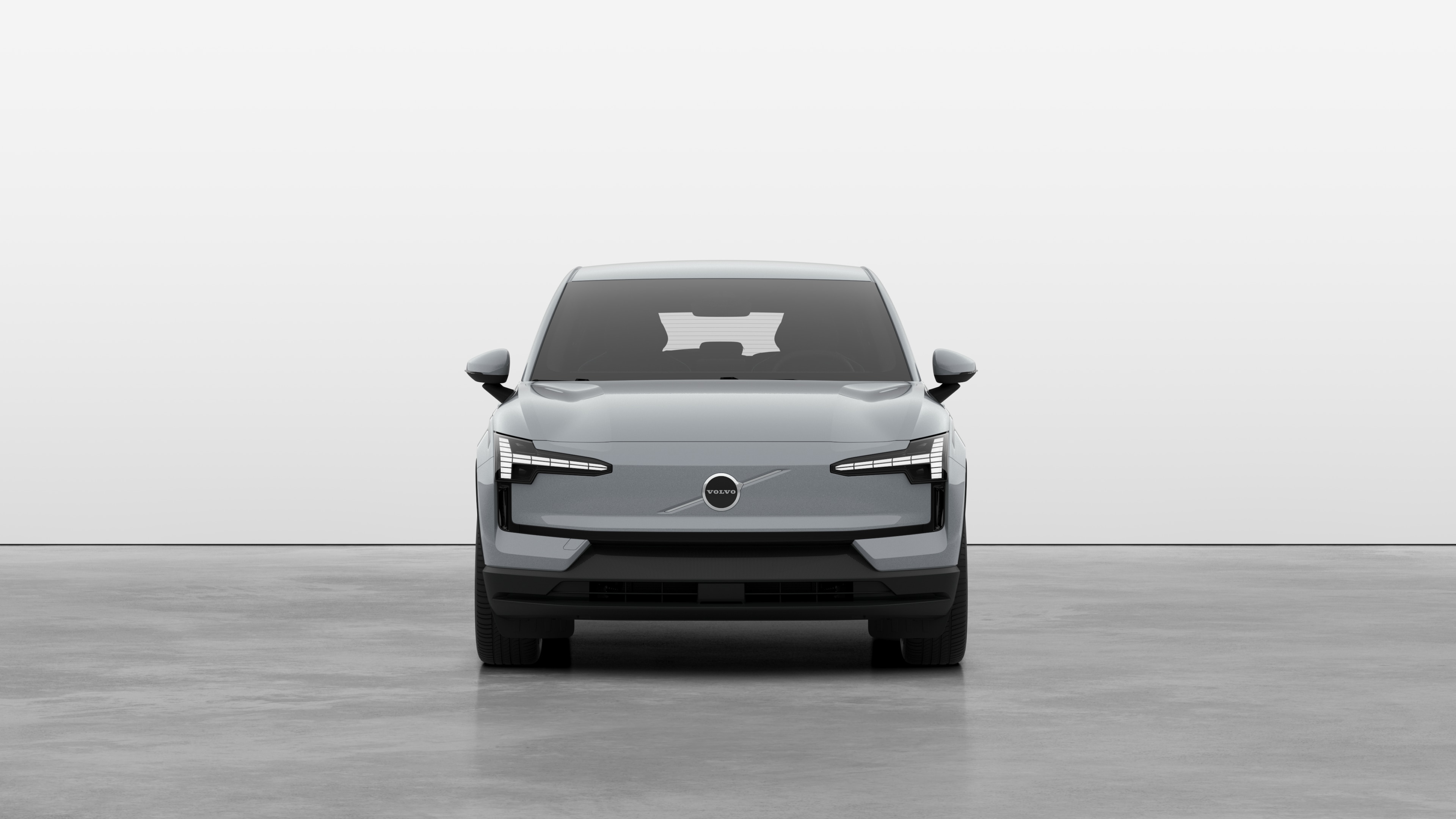 Vista frontal de um carro Volvo em um fundo de estúdio simples.