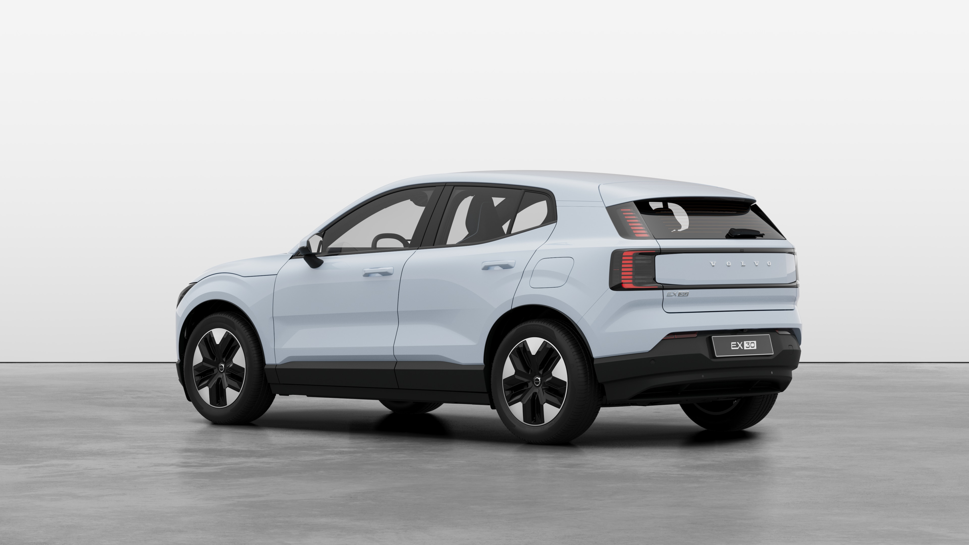 Volvo car rear three-quarter view in a plain studio background.