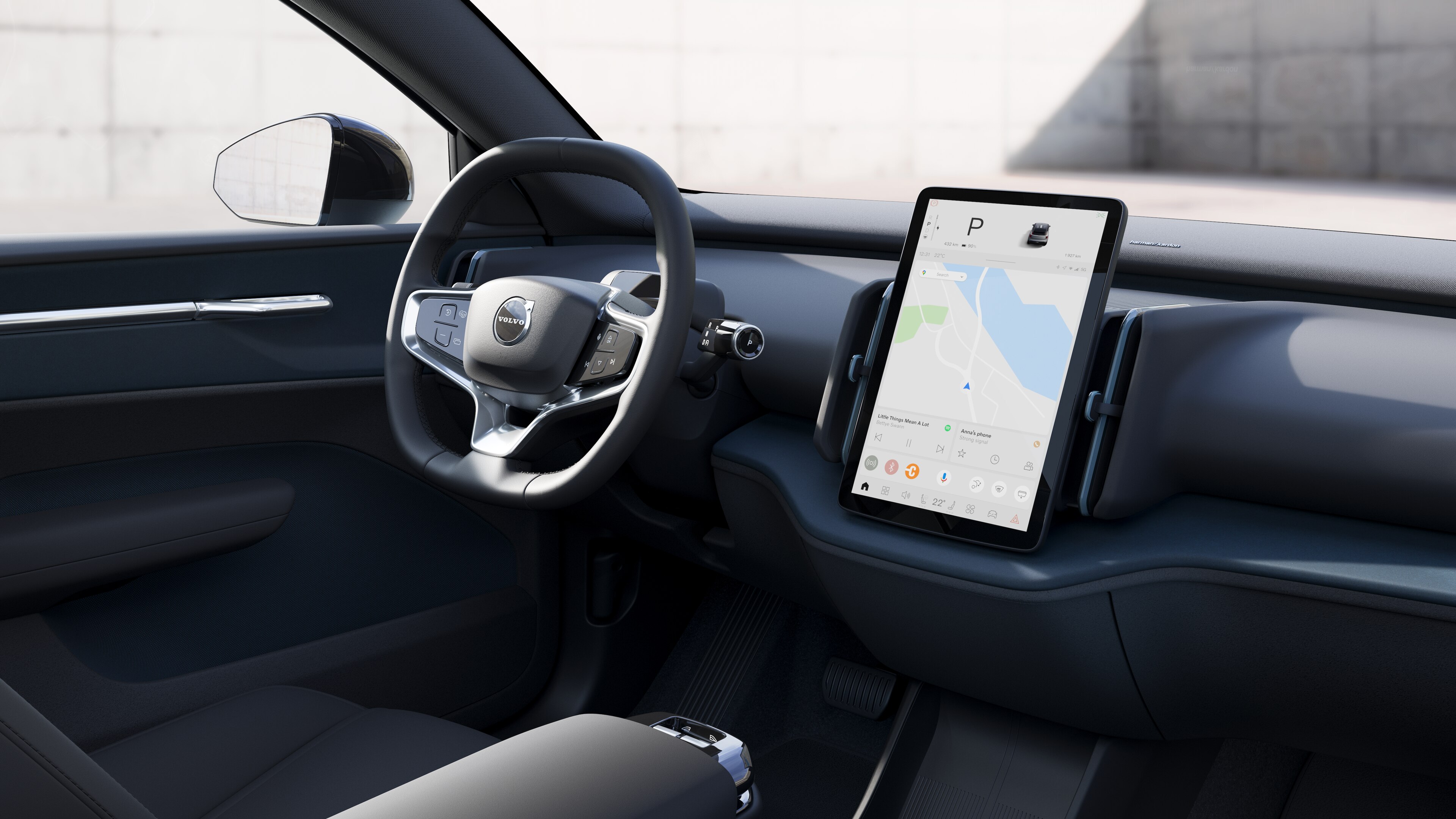 Volvo car interior showing dashboard, steering wheel, and center console with digital display in an open road background.