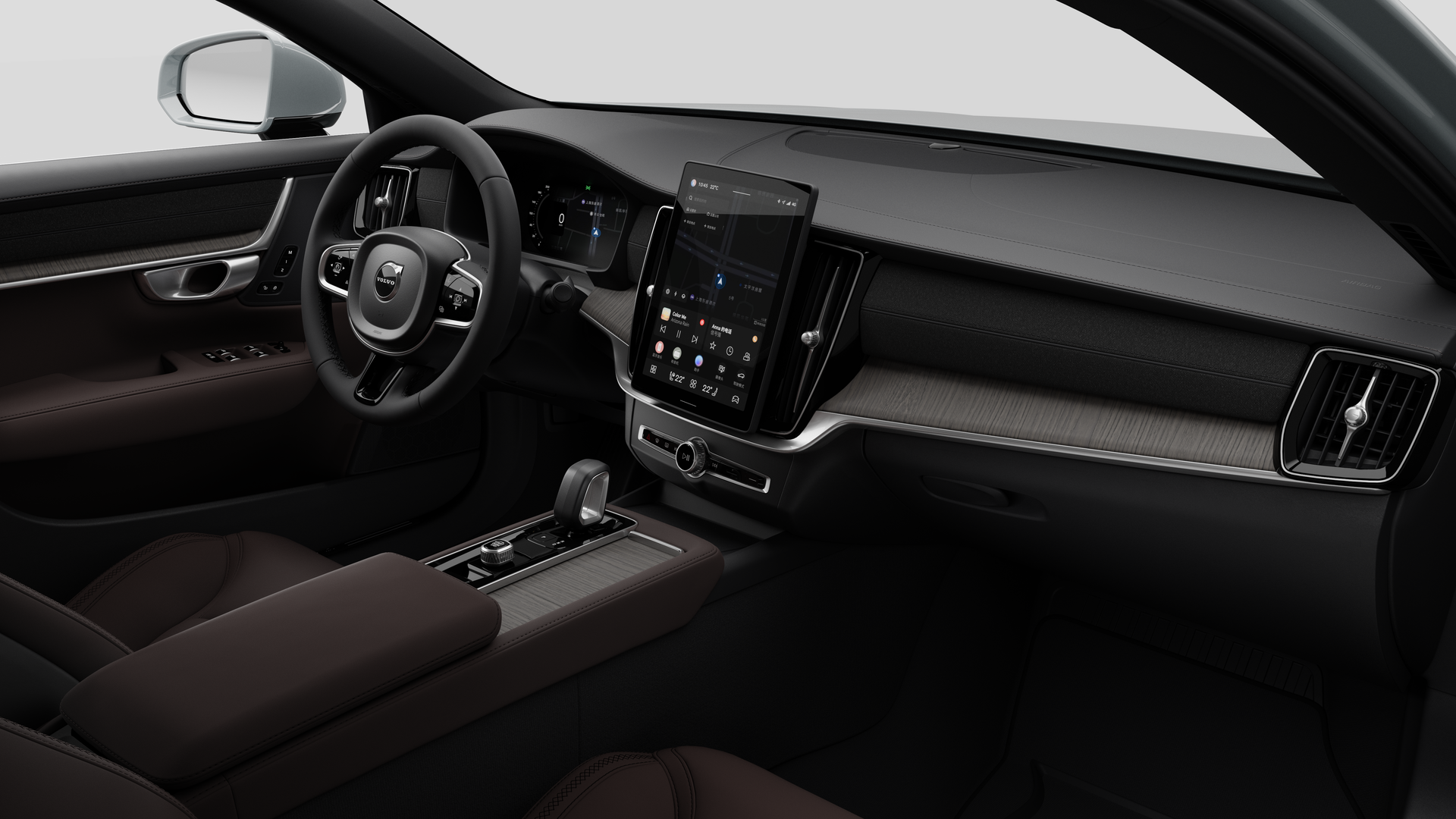 Interior view of a Volvo car showing the dashboard, steering wheel, center console, and digital display screen in a plain studio background.