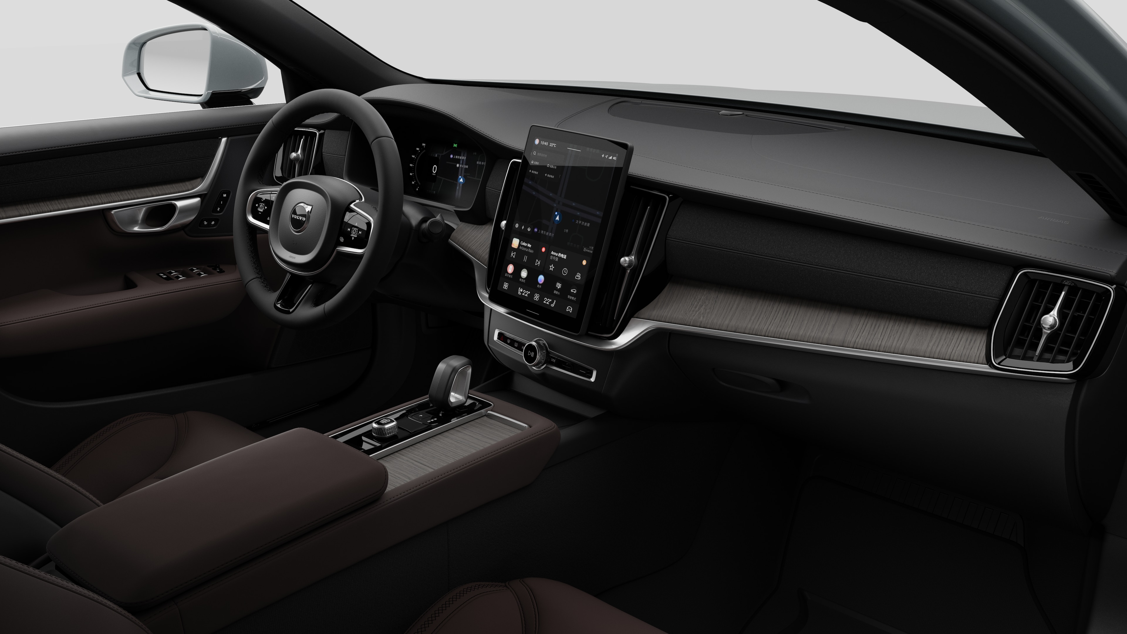 Interior view of a Volvo car showing the dashboard, steering wheel, center console, and digital display screen in a plain studio background.