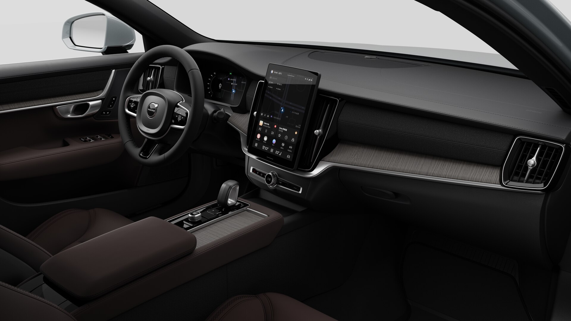 Interior view of a Volvo car showing the dashboard, steering wheel, center console, and digital display screen in a plain studio background.