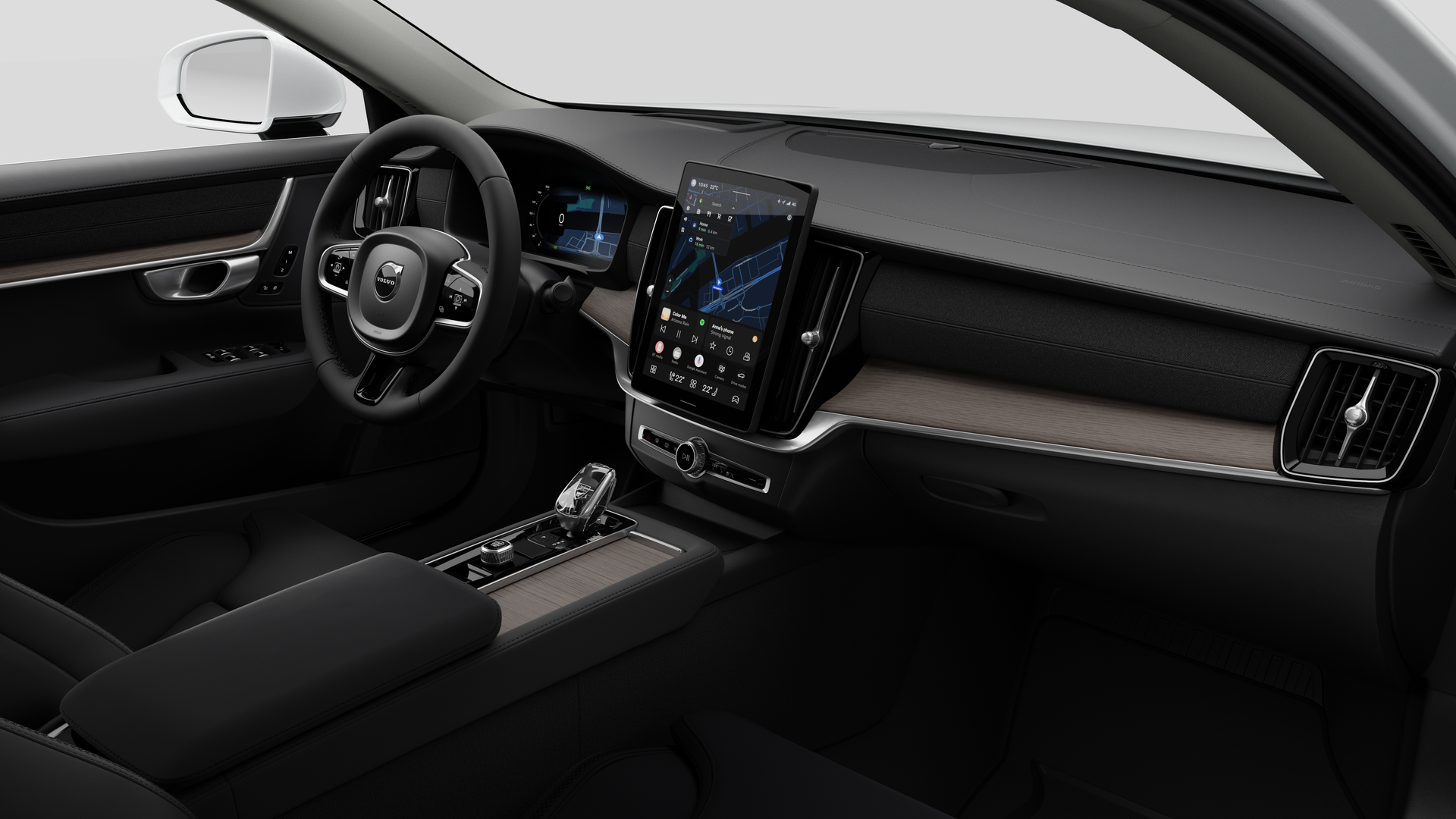 대시보드, 스티어링 휠, 센터 콘솔 및 디지털 디스플레이 화면을 평범한 스튜디오 배경에 보여주는 Volvo 자동차의 내부 모습.