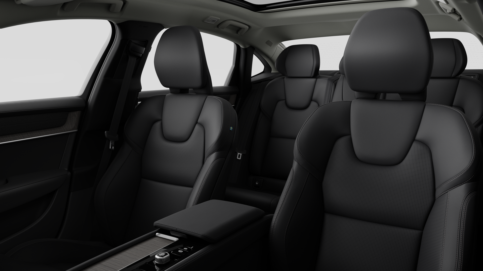 Volvo car interior showing rear passenger seats and center console in plain studio background.