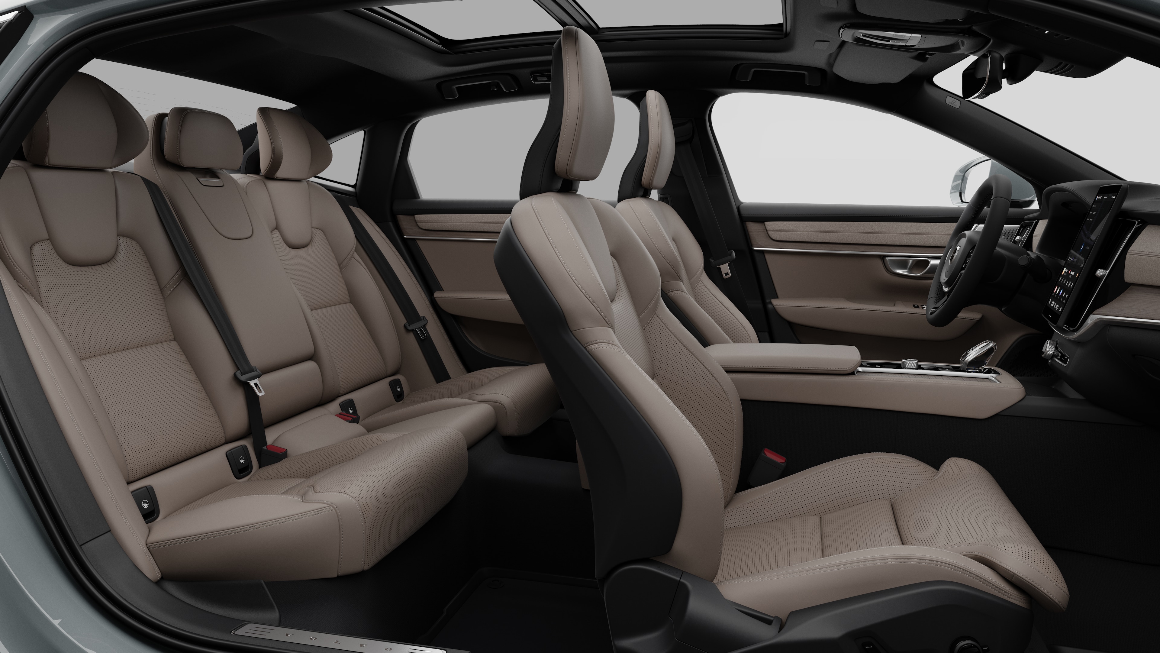 Volvo car interior side view showcasing front seats, rear passenger seats, steering wheel, dashboard, and center console, set against plain studio background.