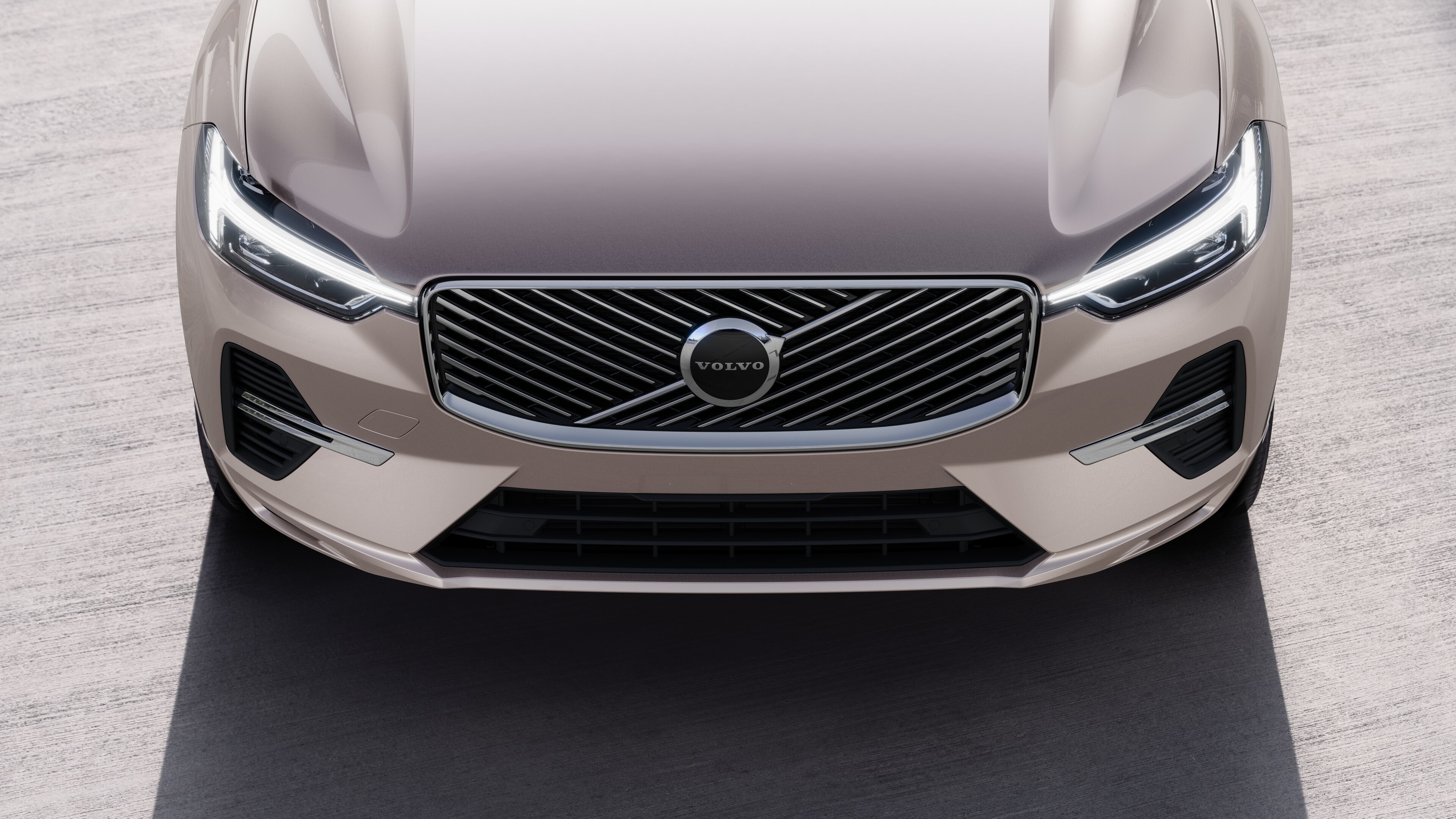 Volvo car exterior in three-quarter view on an urban street background, showing one side, roof, and part of the front.