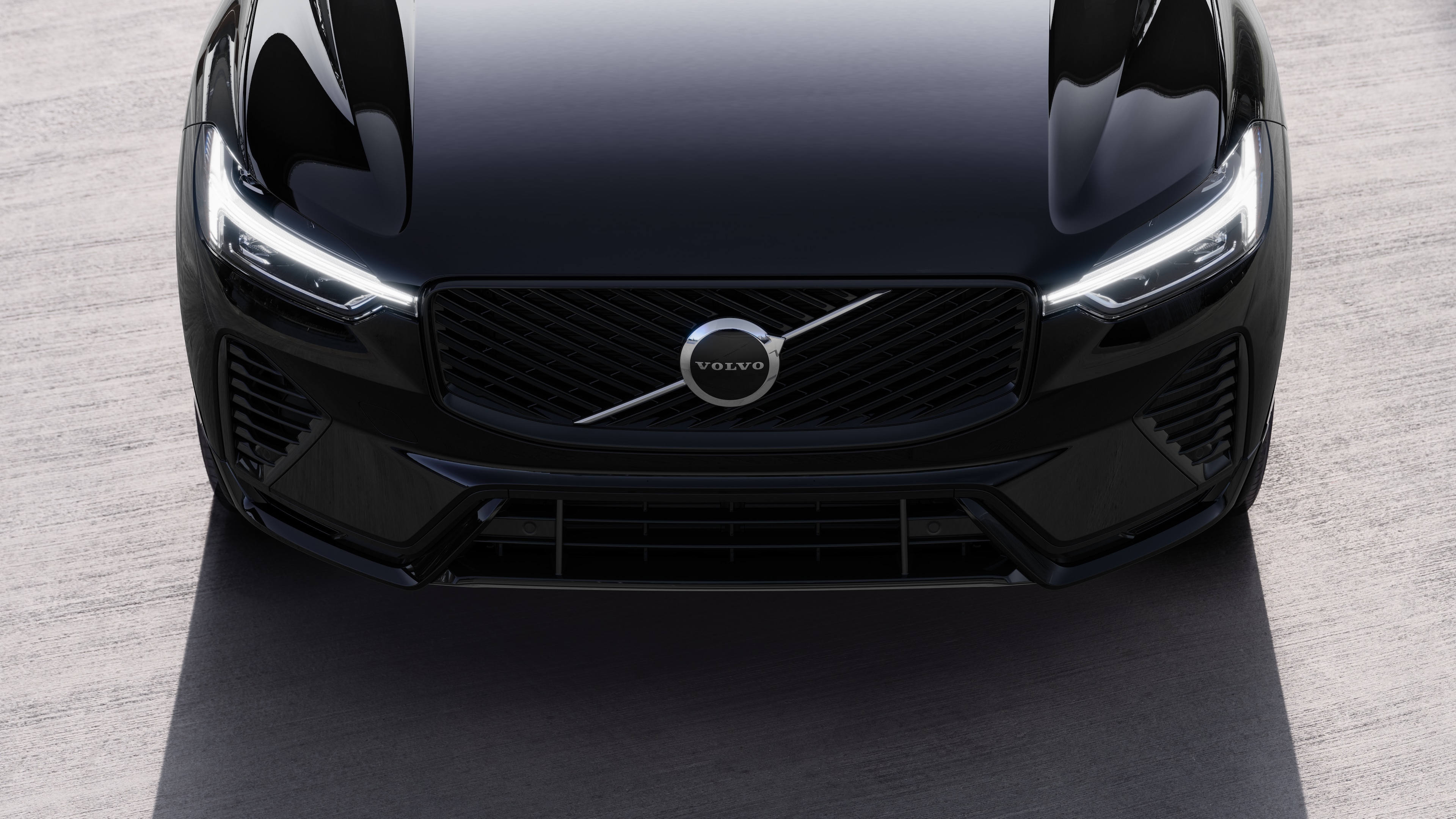 Volvo car exterior in three-quarter view on an urban street background, showing one side, roof, and part of the front.