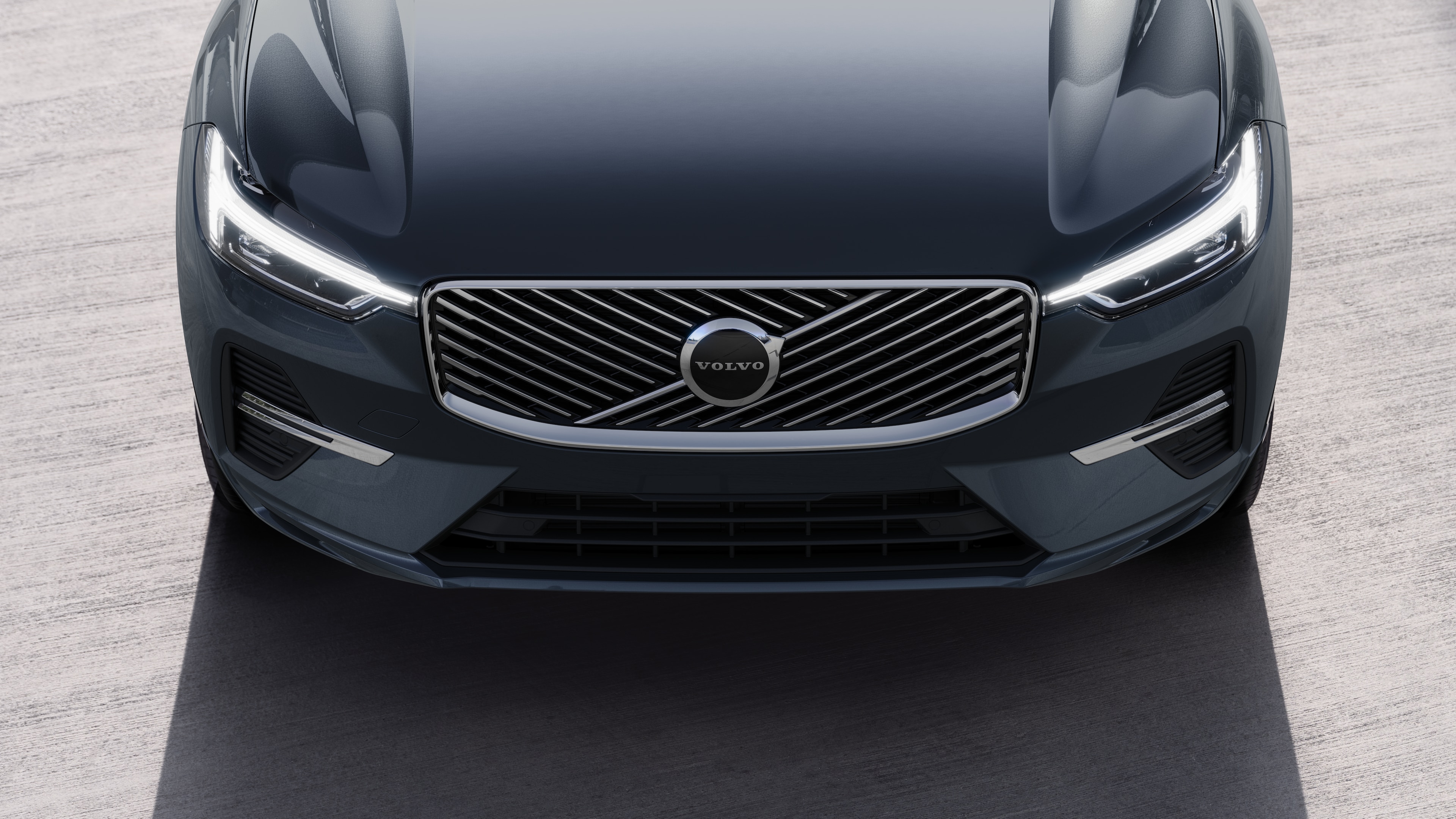 Volvo car exterior in three-quarter view on an urban street background, showing one side, roof, and part of the front.