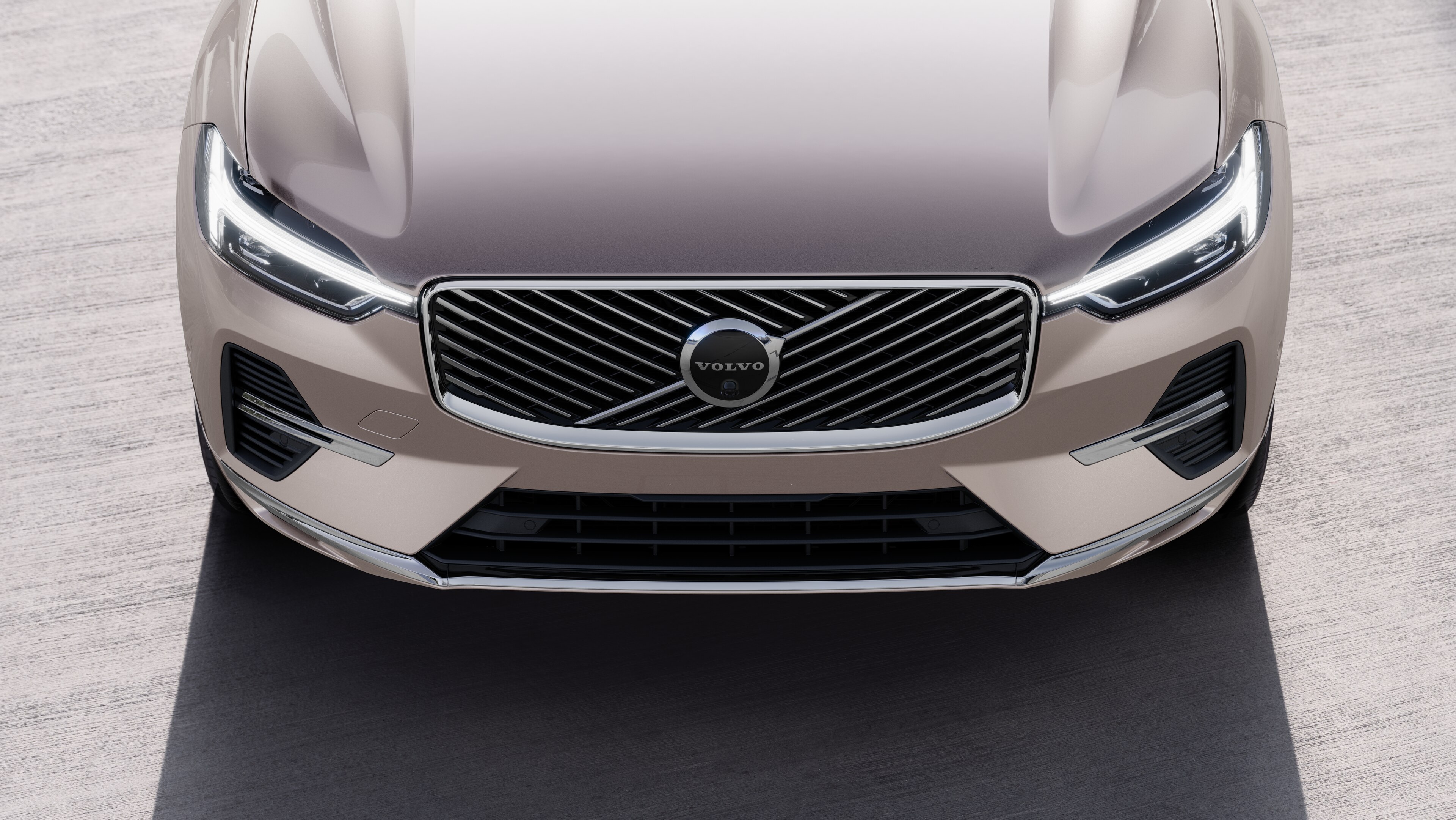 Volvo car exterior in three-quarter view on an urban street background, showing one side, roof, and part of the front.