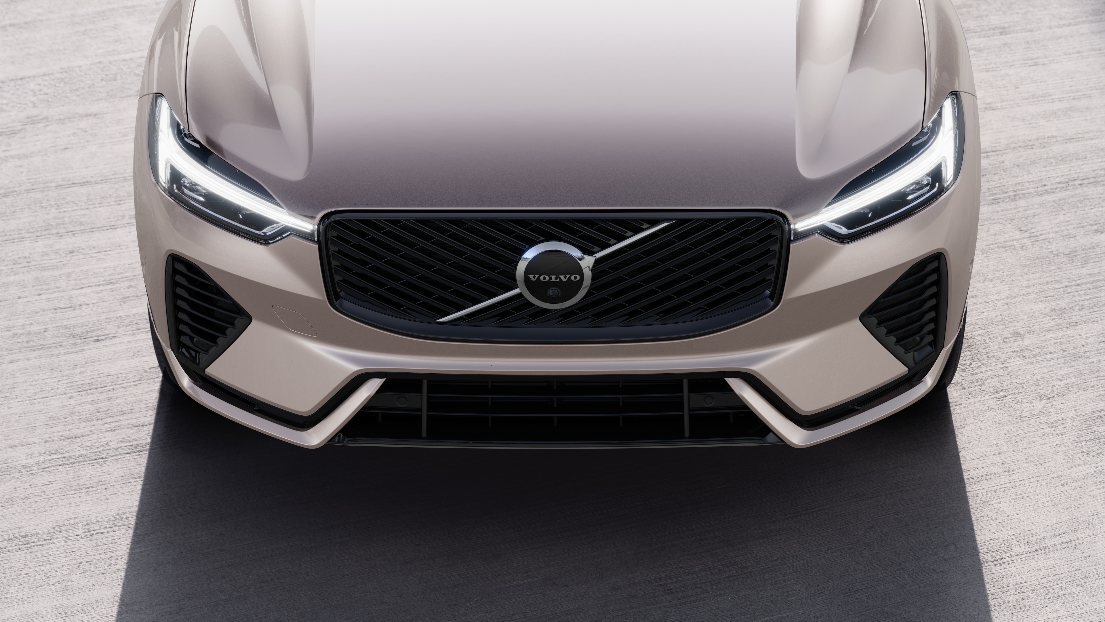 Volvo car exterior in three-quarter view on an urban street background, showing one side, roof, and part of the front.