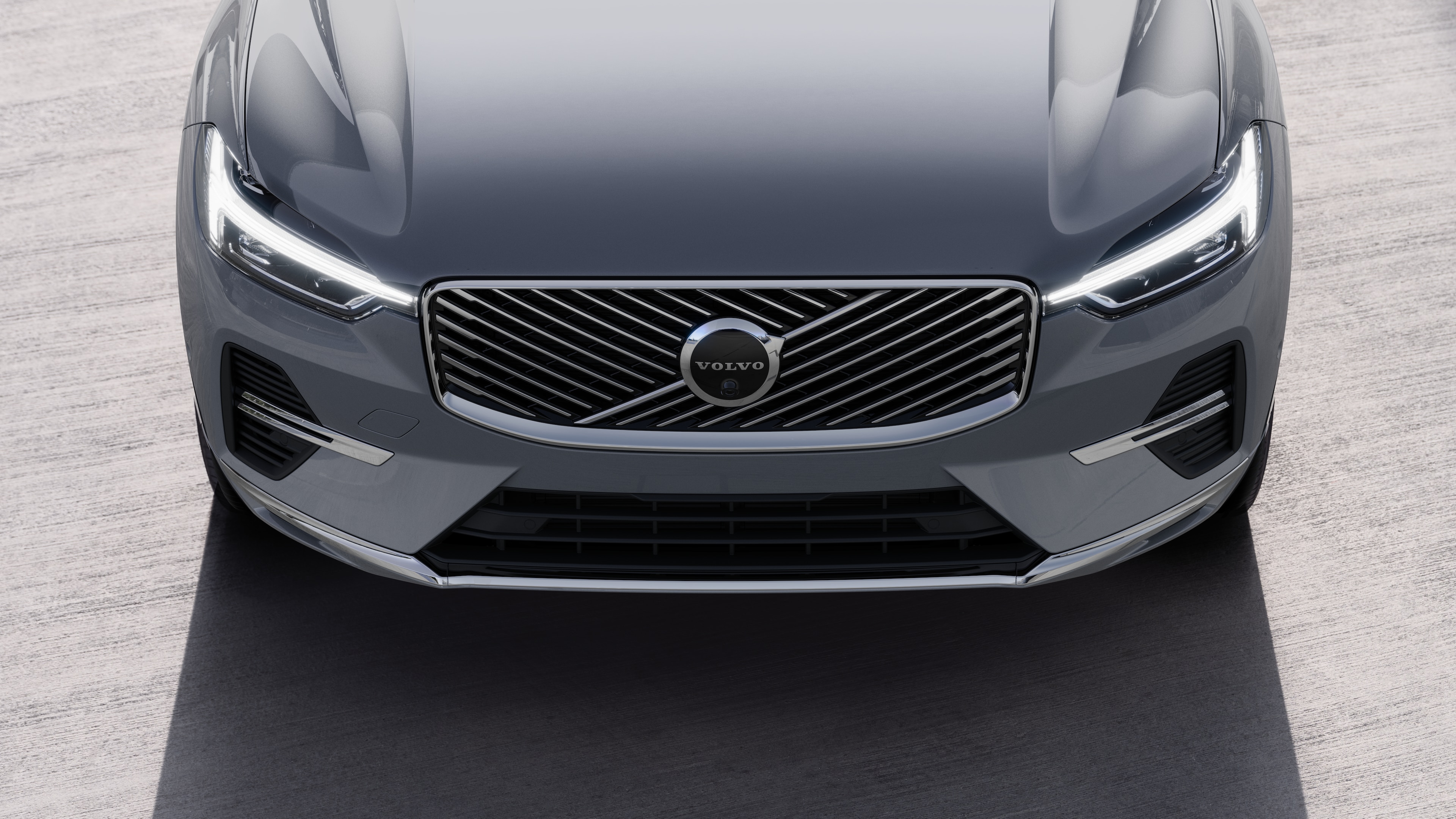 Volvo car exterior in three-quarter view on an urban street background, showing one side, roof, and part of the front.