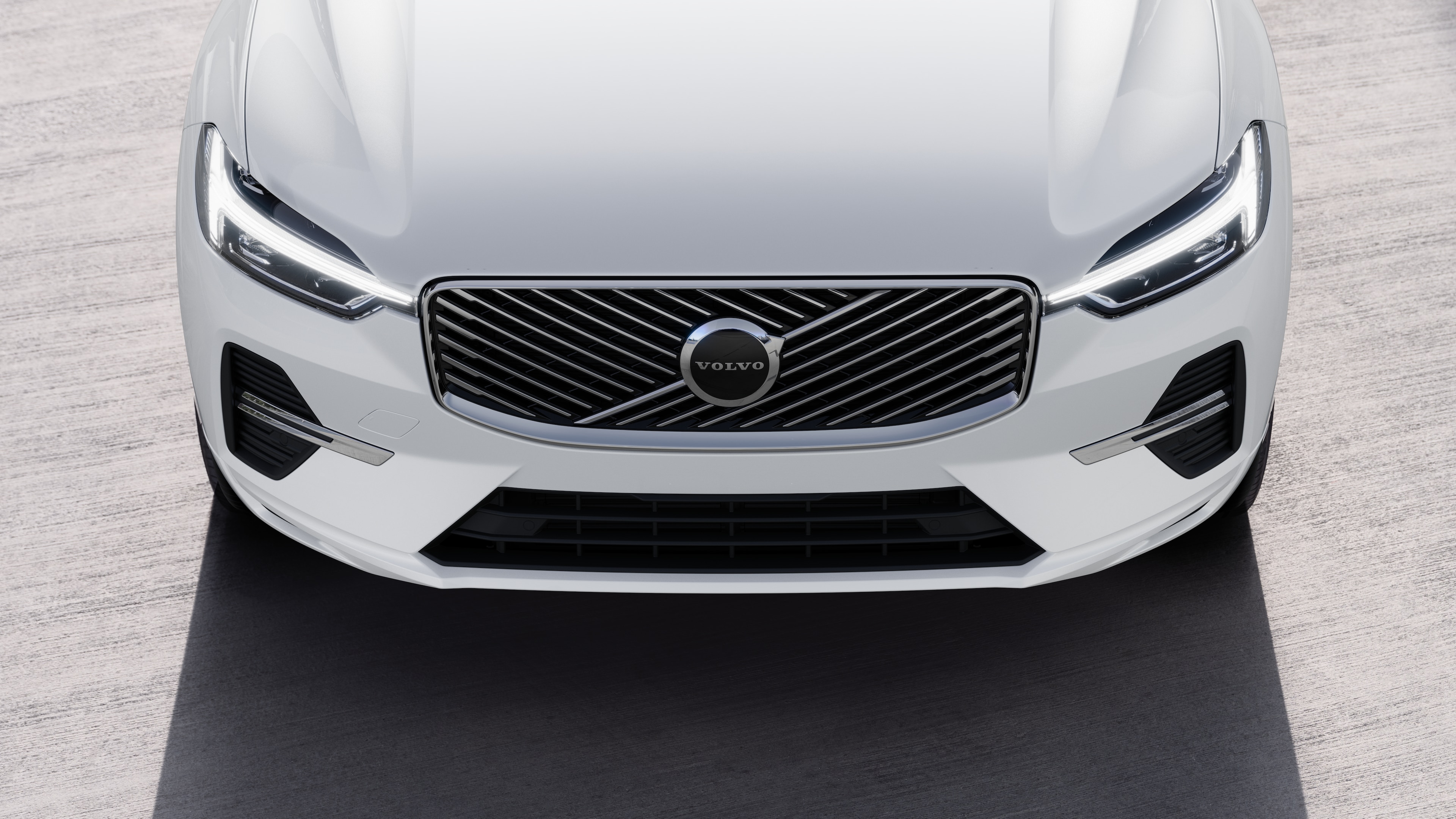 Volvo car exterior in three-quarter view on an urban street background, showing one side, roof, and part of the front.