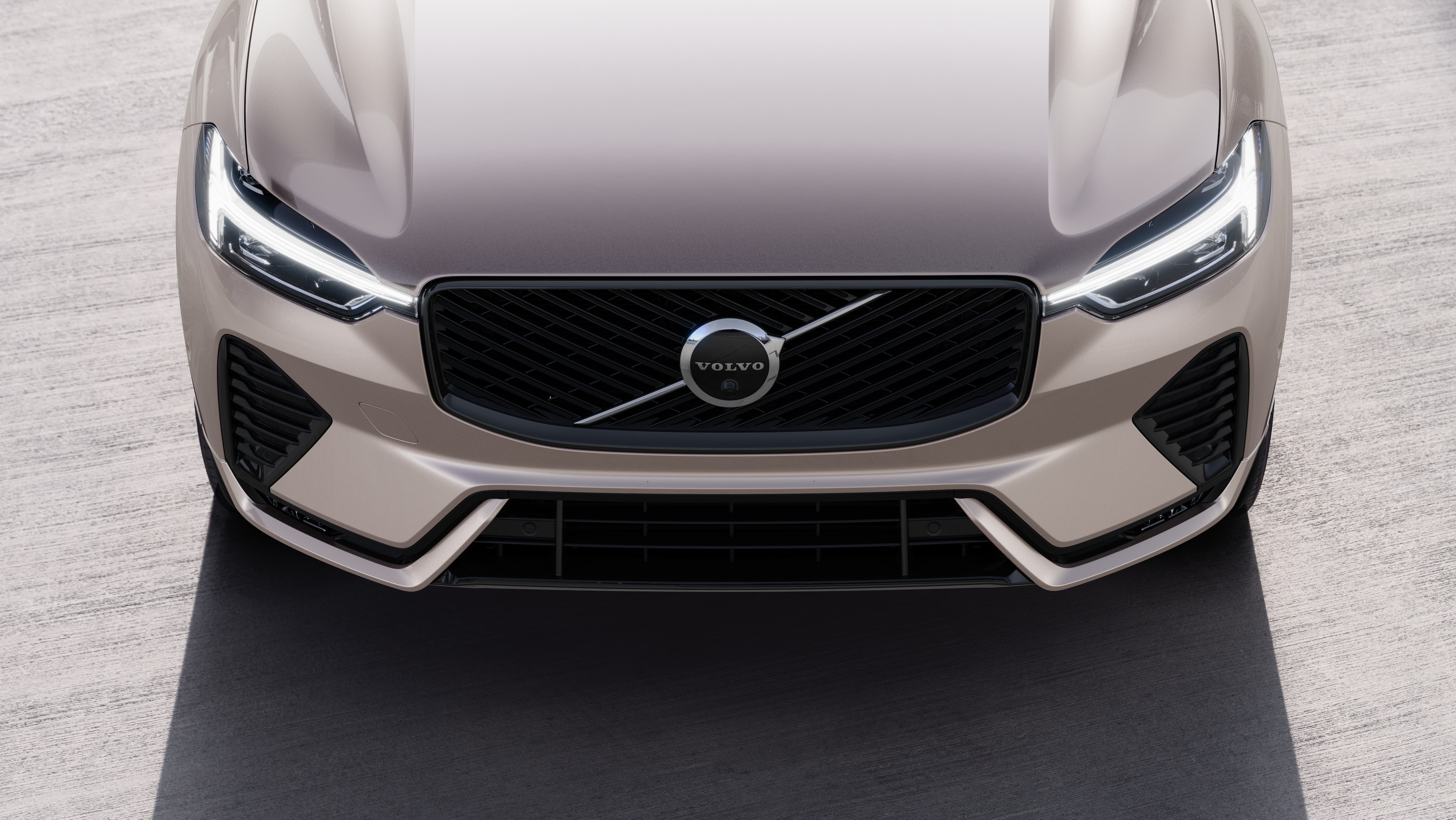 Volvo car exterior in three-quarter view on an urban street background, showing one side, roof, and part of the front.