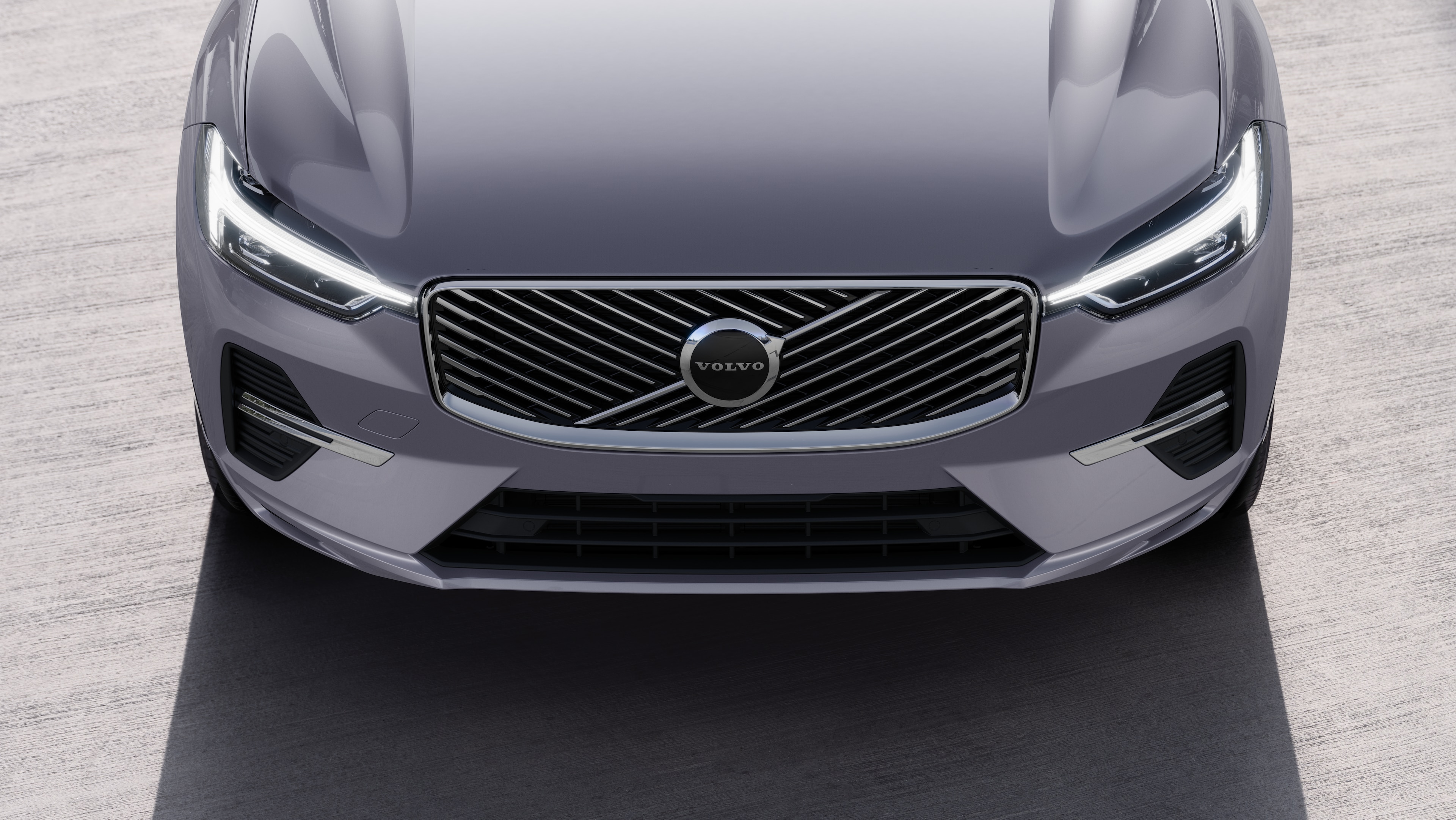 Volvo car exterior in three-quarter view on an urban street background, showing one side, roof, and part of the front.