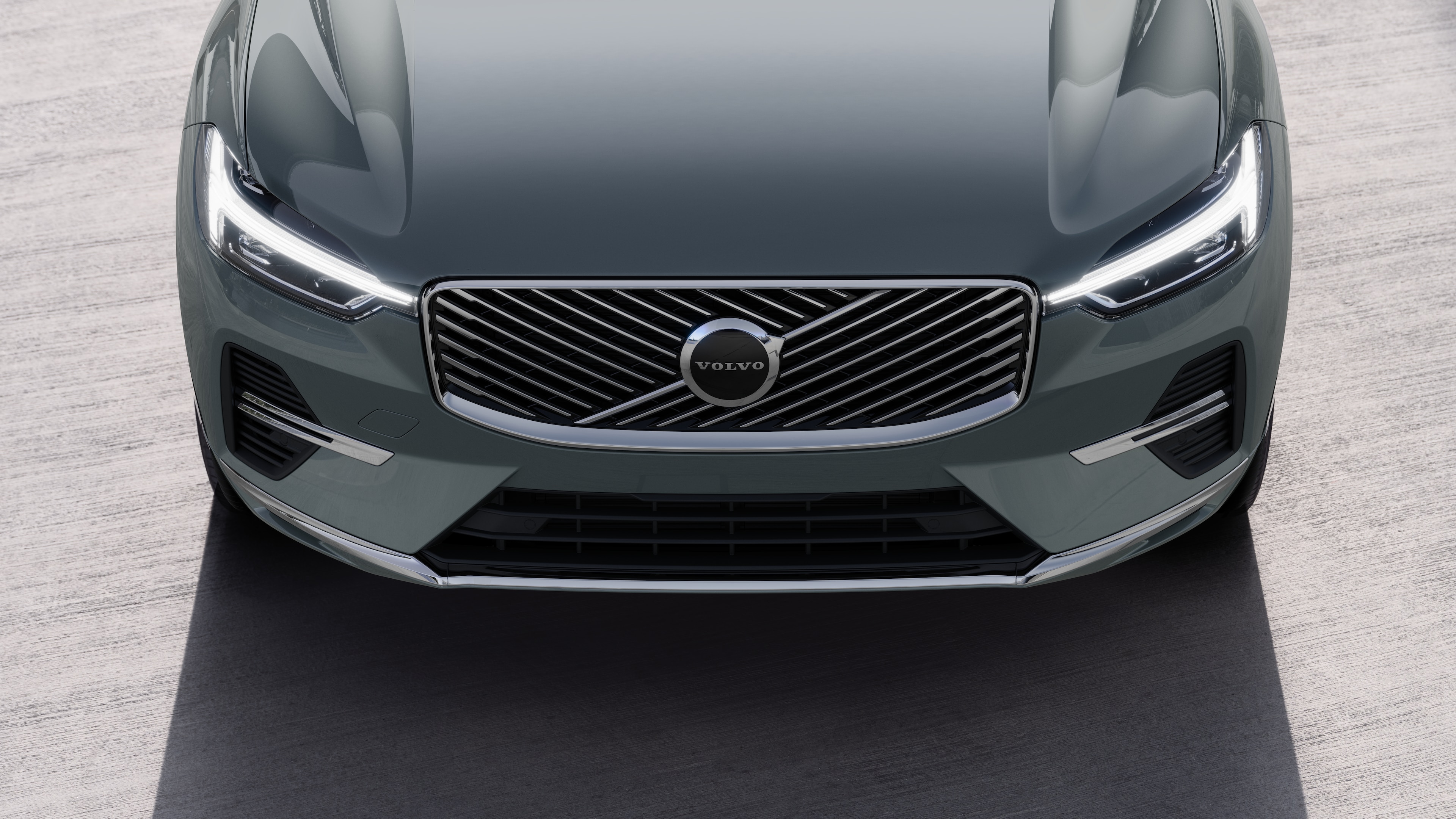 Volvo car exterior in three-quarter view on an urban street background, showing one side, roof, and part of the front.