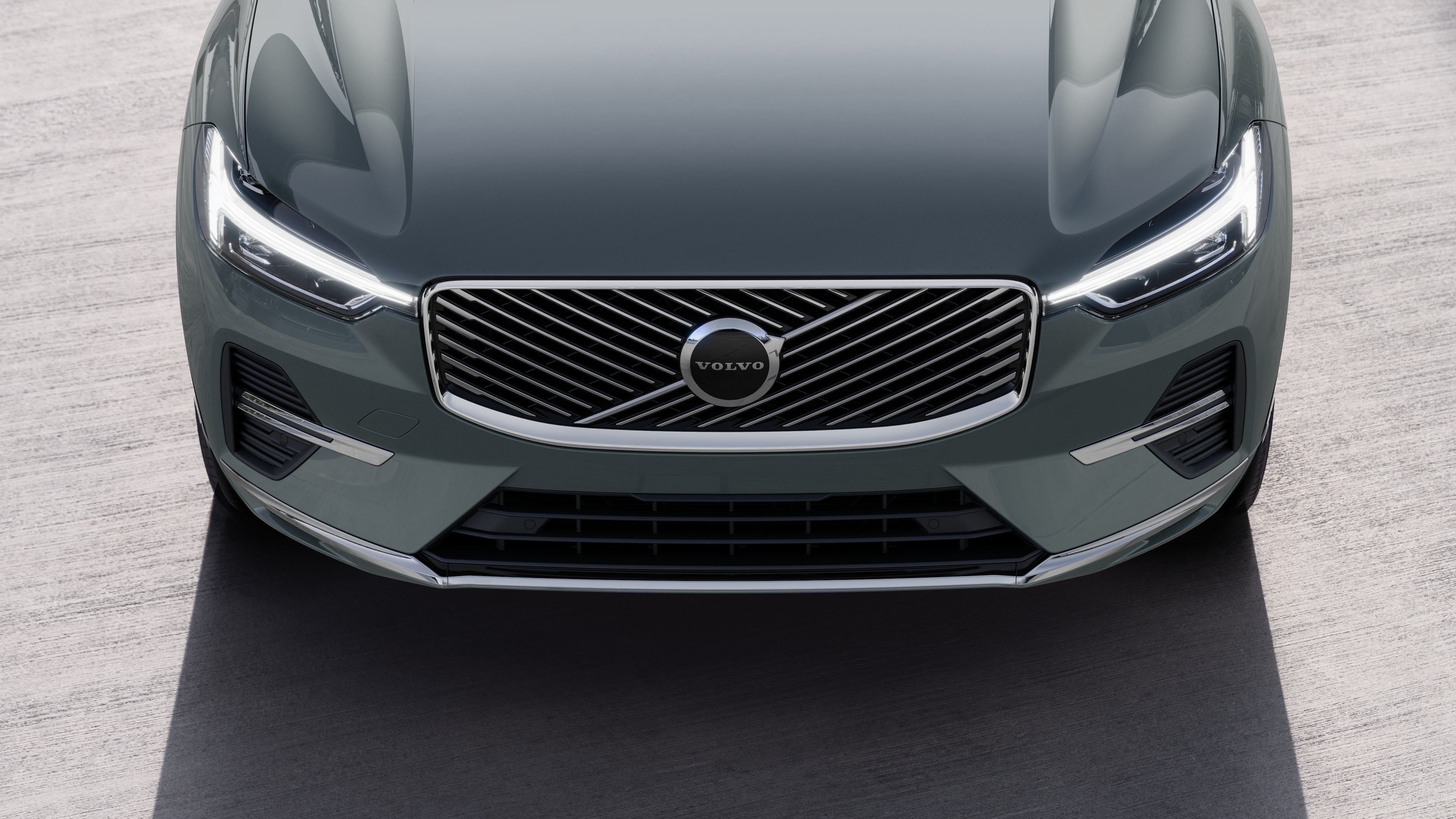 Volvo car exterior in three-quarter view on an urban street background, showing one side, roof, and part of the front.