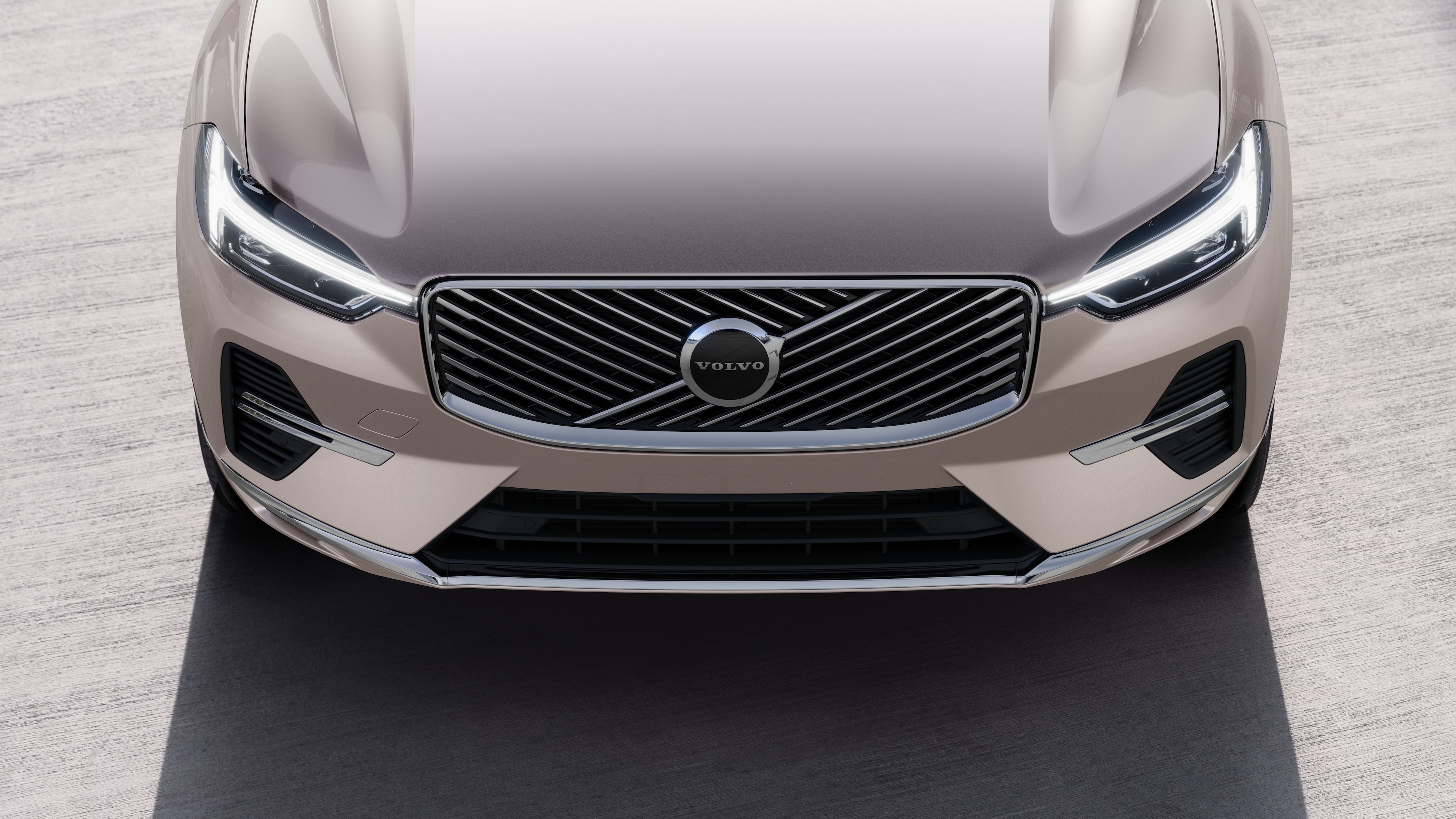 Volvo car exterior in three-quarter view on an urban street background, showing one side, roof, and part of the front.